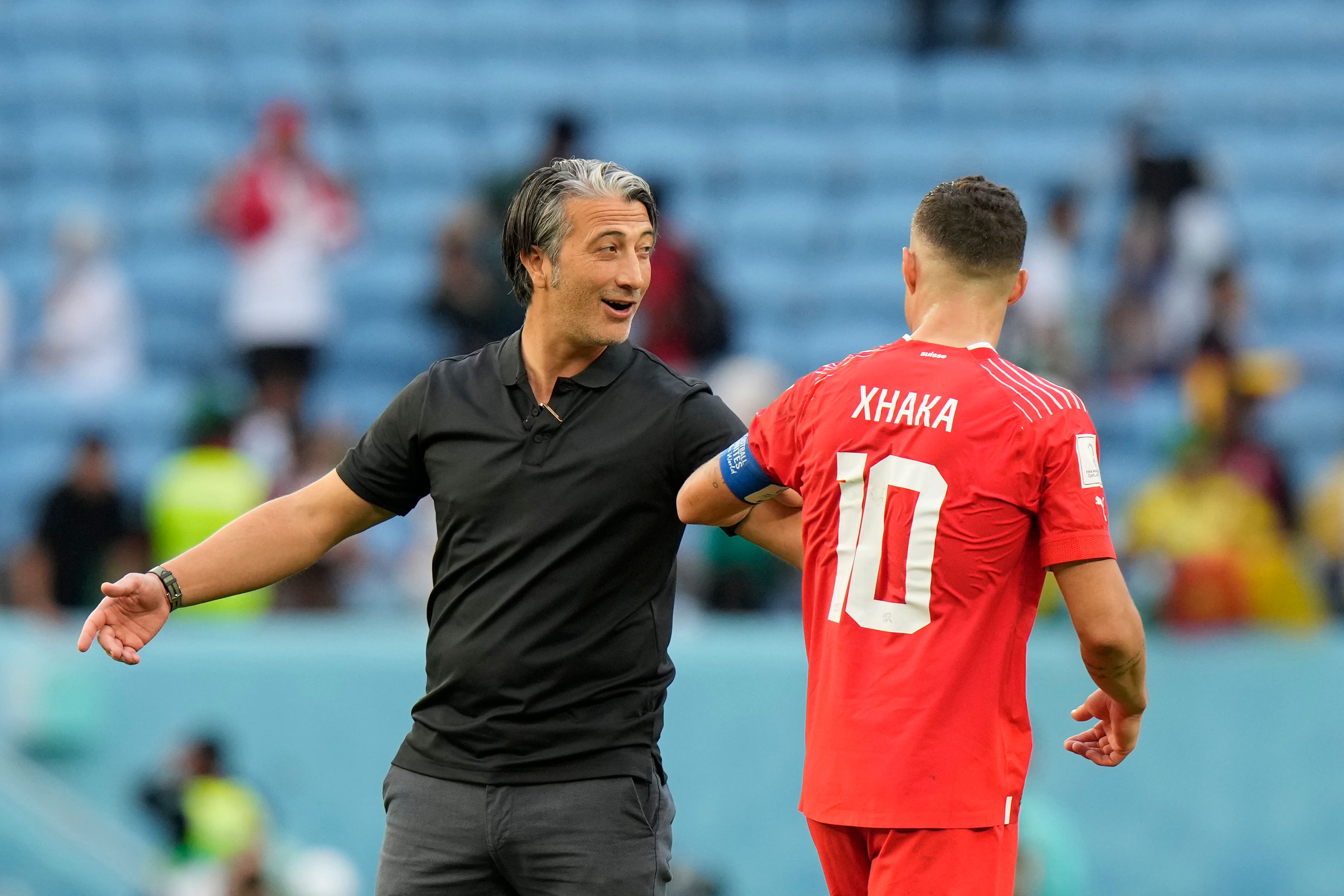 Switzerland head coach Murat Yakin, left, celebrates victory (Luca Bruno/AP)