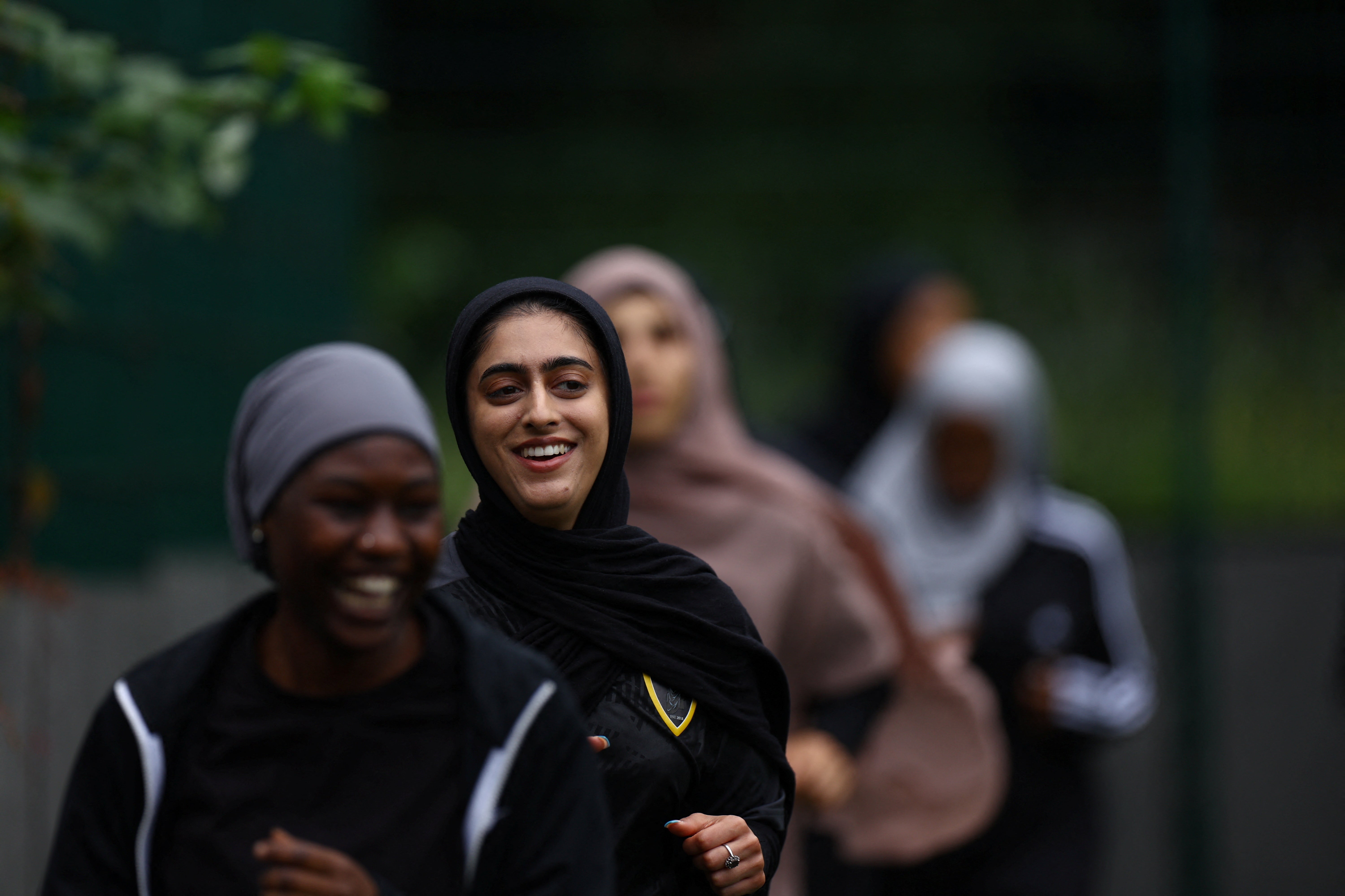 Fatima jogs around the pitch during warm up at a Sisterhood training session