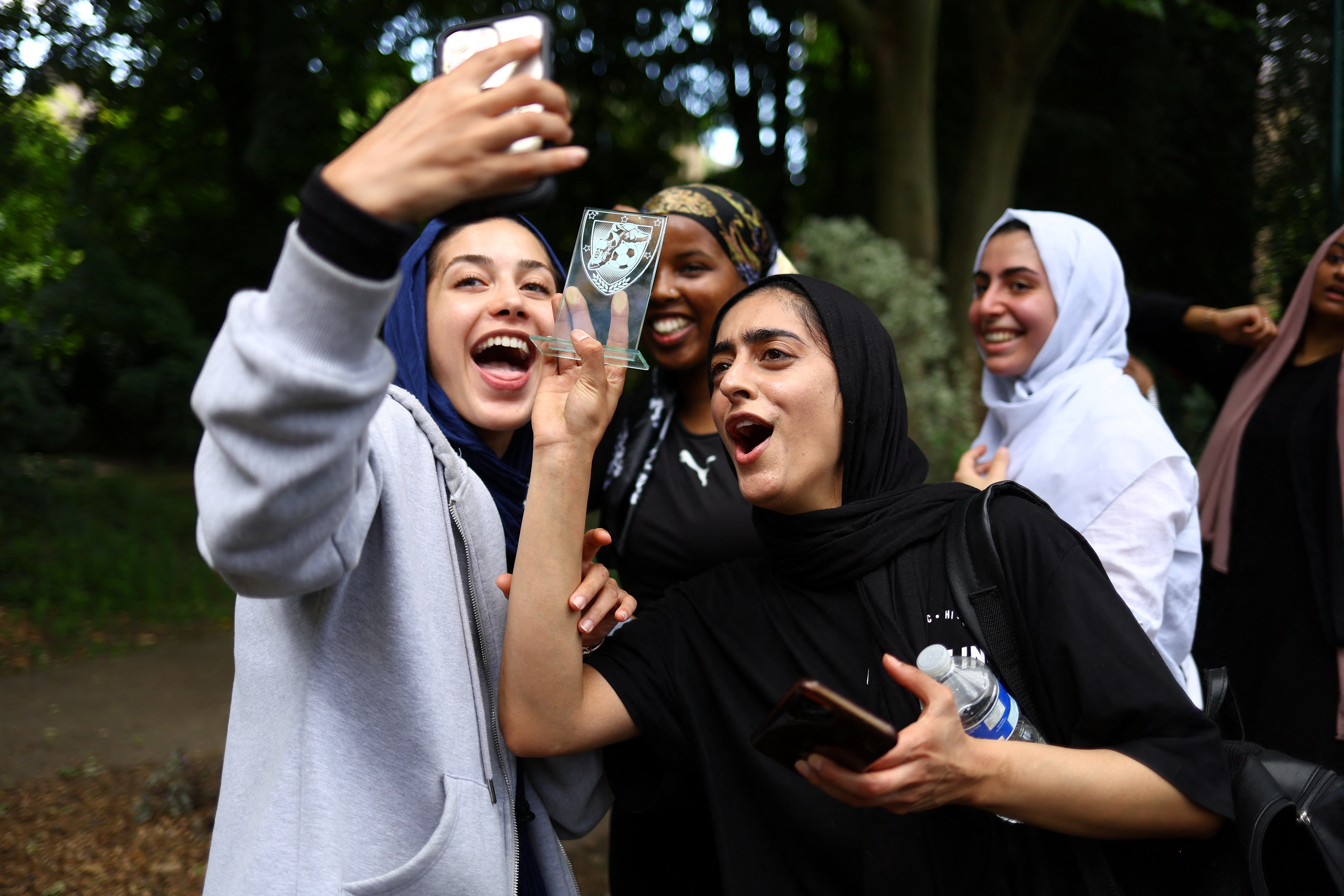 Fatima, and Sara Taleghani, 25, video-call the founder, Yasmin, to celebrate their first match win