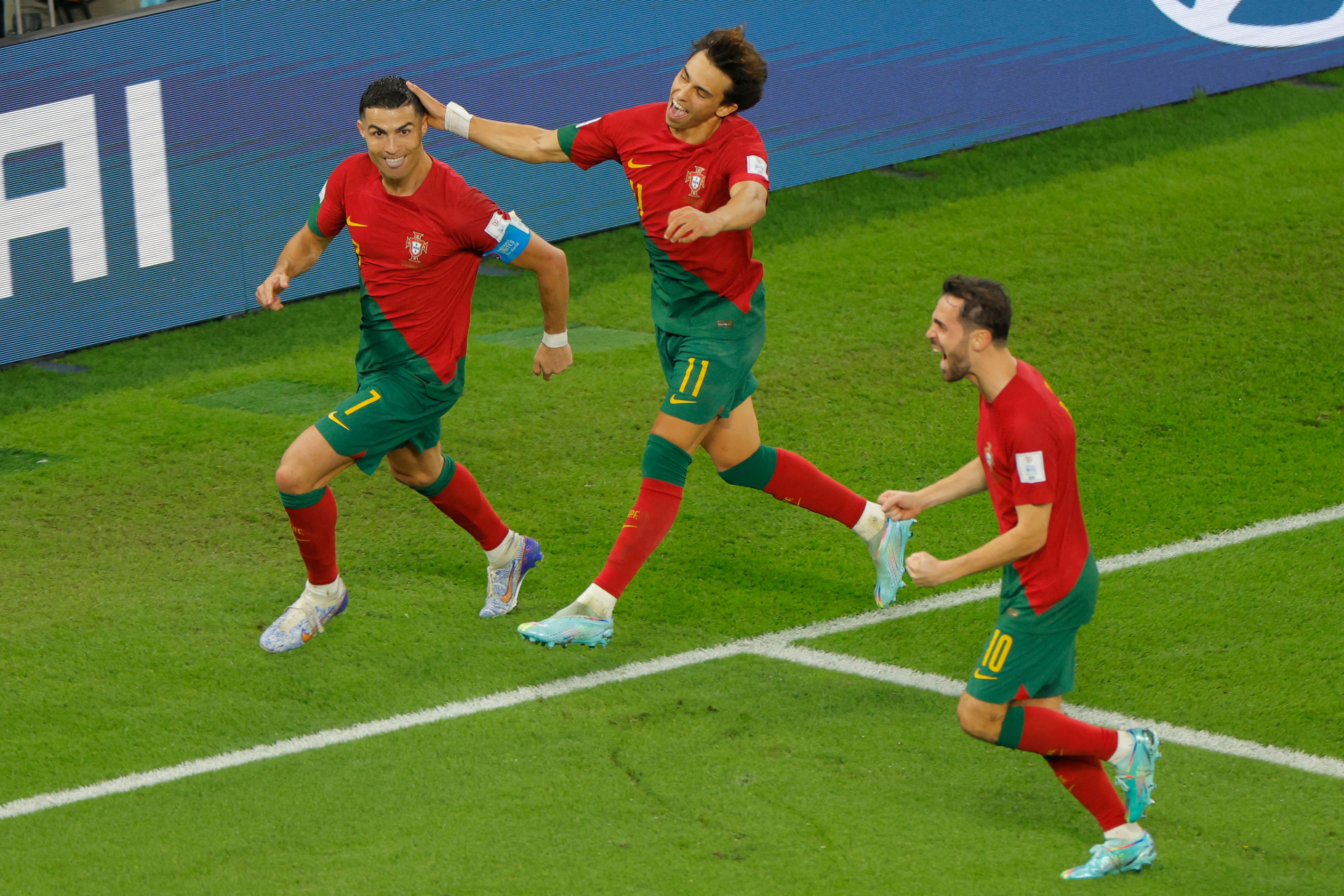 Ronaldo celebrates with Joao Felix (centre) and Bernardo Silva