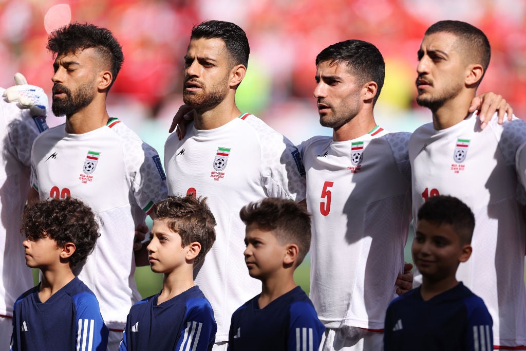 Iran’s players sing the national anthem