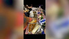 New Yorkers serve elaborate Thanksgiving meal from dinner table inside Subway carriage