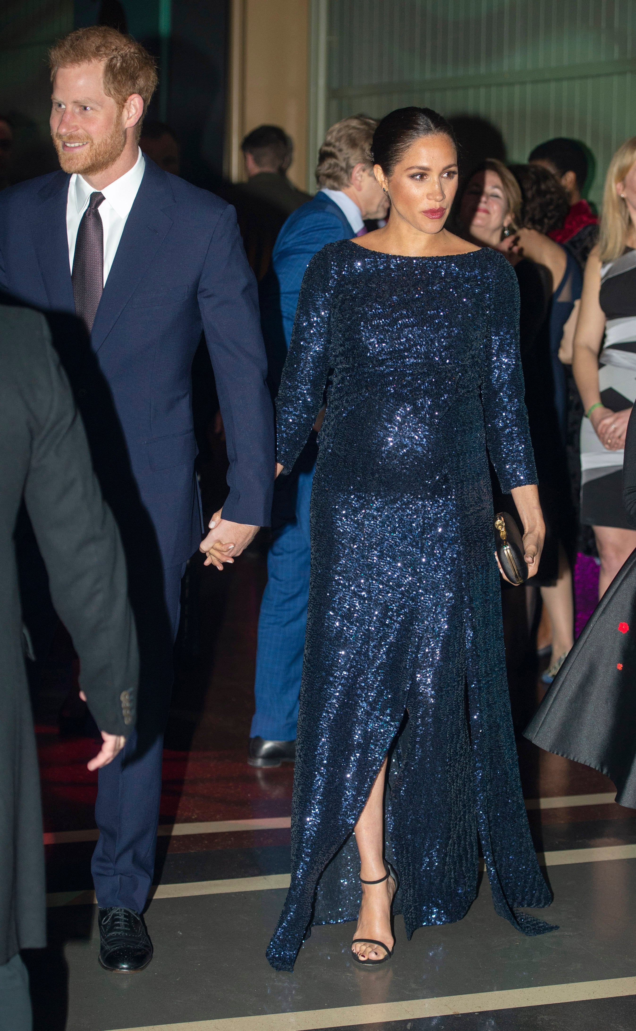 The Duke and Duchess of Sussex hold hands outside the Royal Albert Hall in London