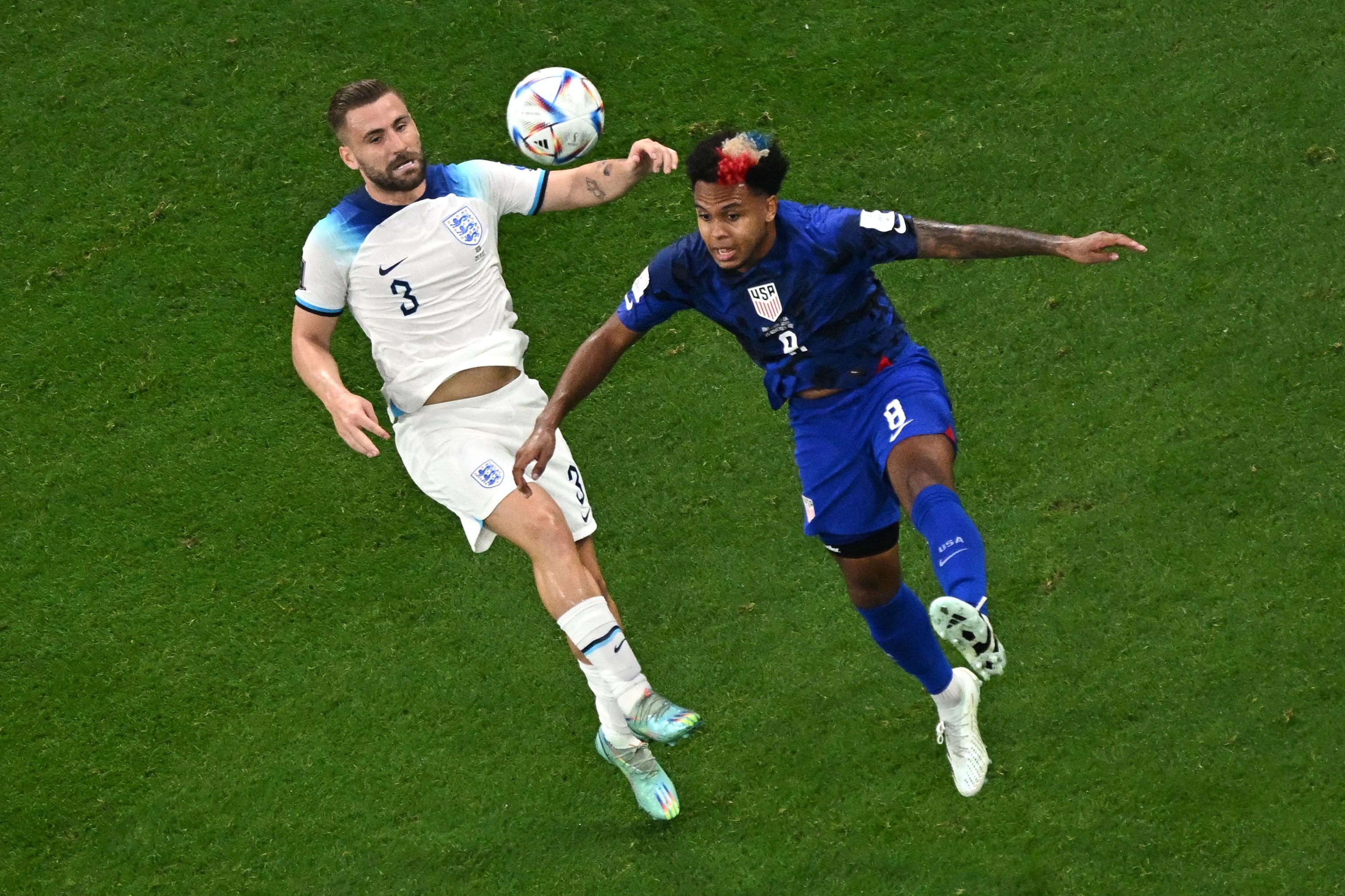 Luke Shaw fights for the ball with Weston McKennie