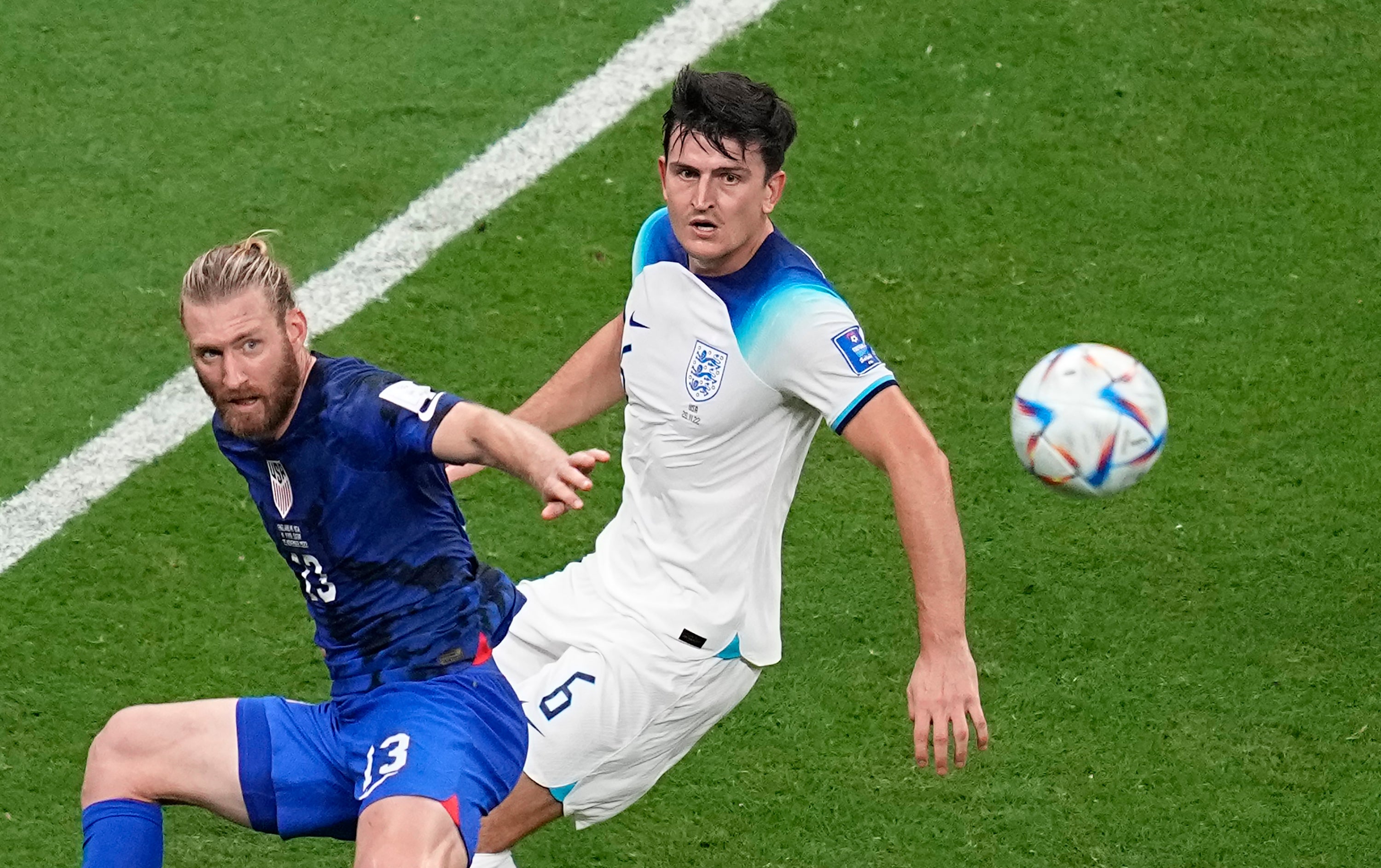 England's Harry Maguire, right, and Tim Ream of the United States fight for the ball