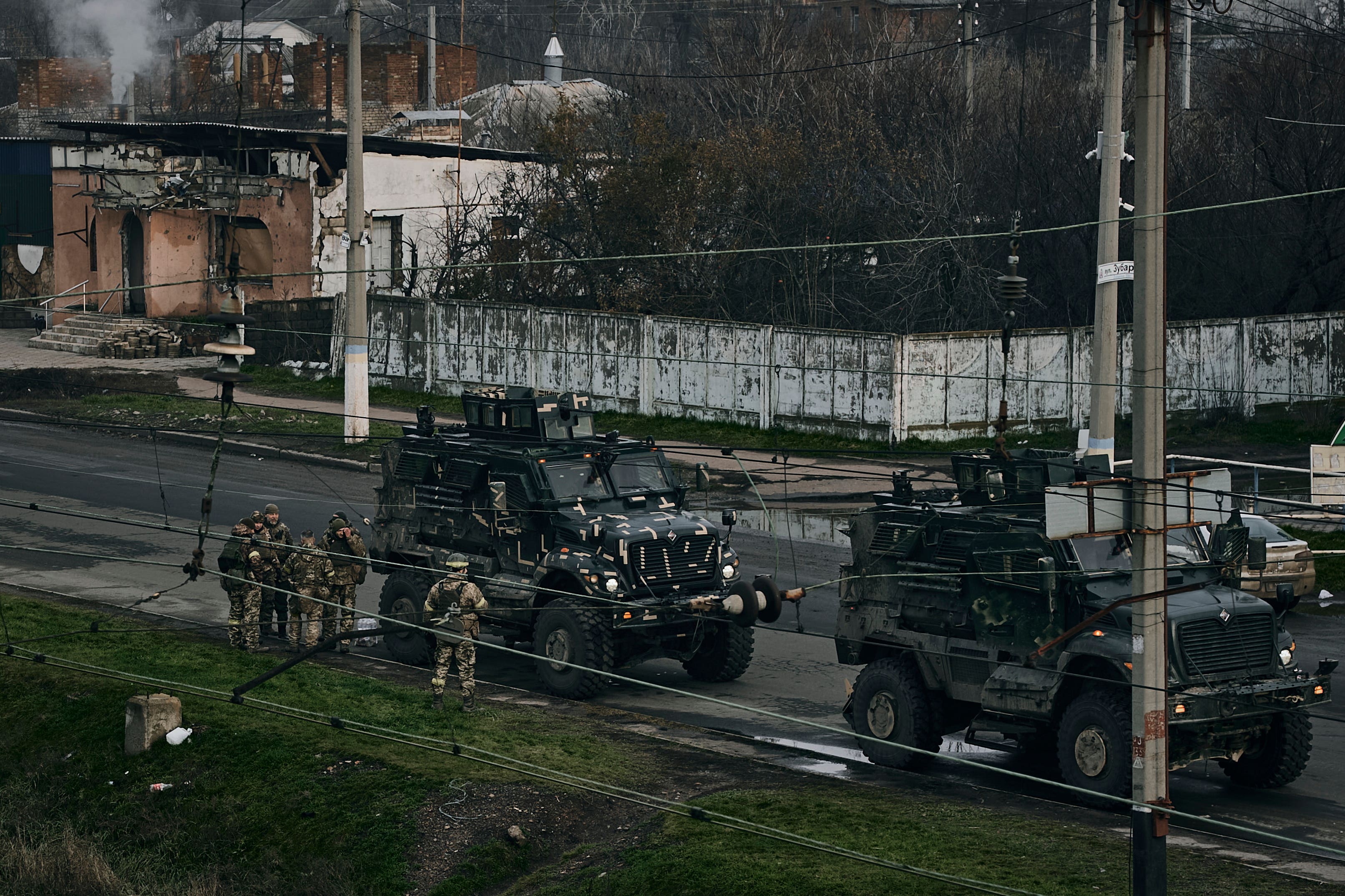 Ukrainian soldiers stand next to army military vehicles near Bakhmut in the Donetsk region (LIBKOS/AP/PA)