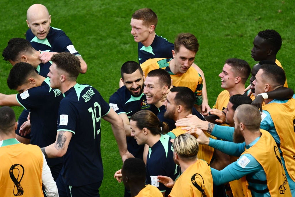 Australia's Mitchell Duke, centre, celebrates with teammates after scoring his team's first goal at Qatar