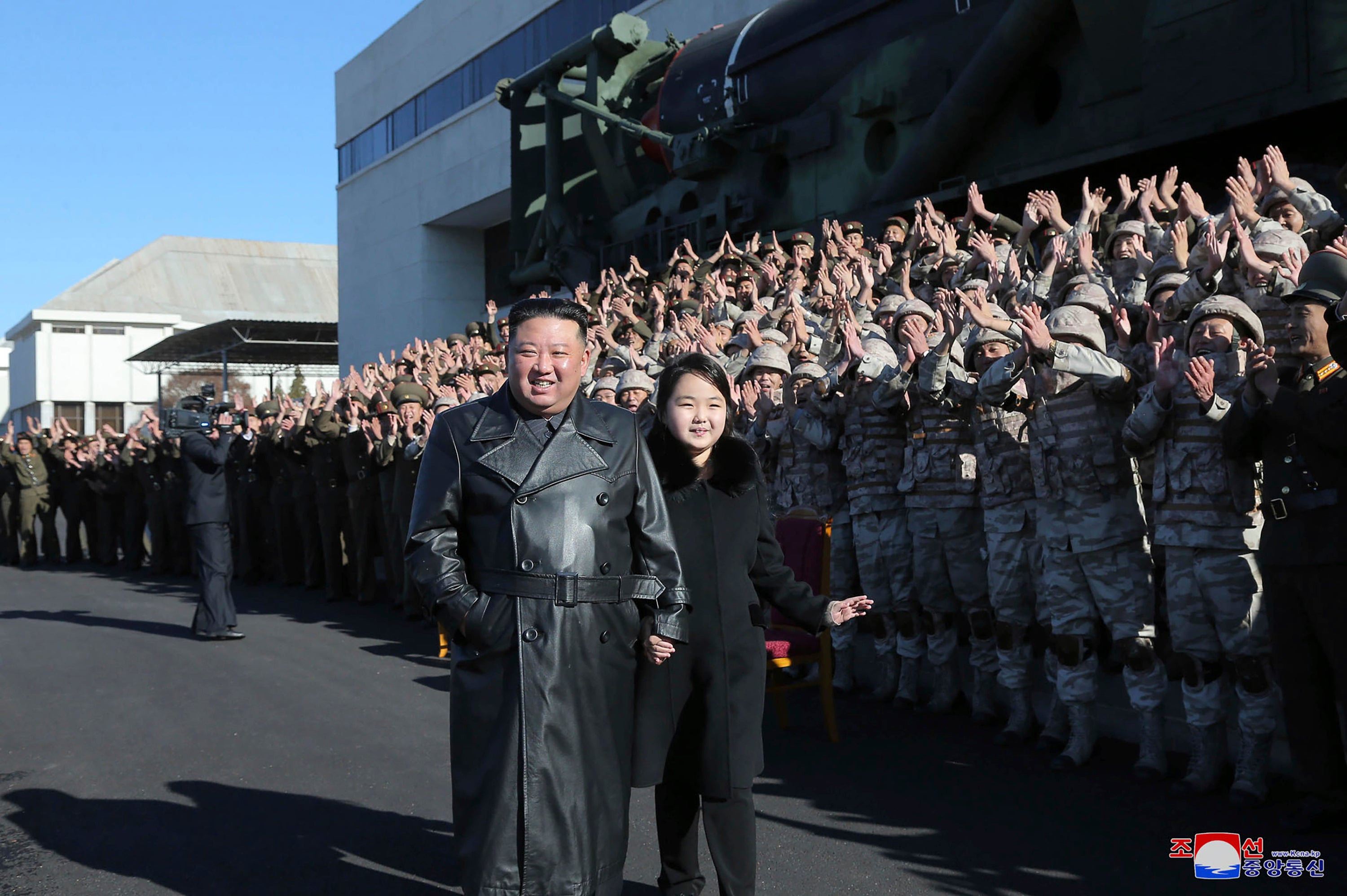 North Korean leader Kim Jong Un and his daughter with soldiers involved in the the recent launch a Hwasong-17 intercontinental ballistic missile