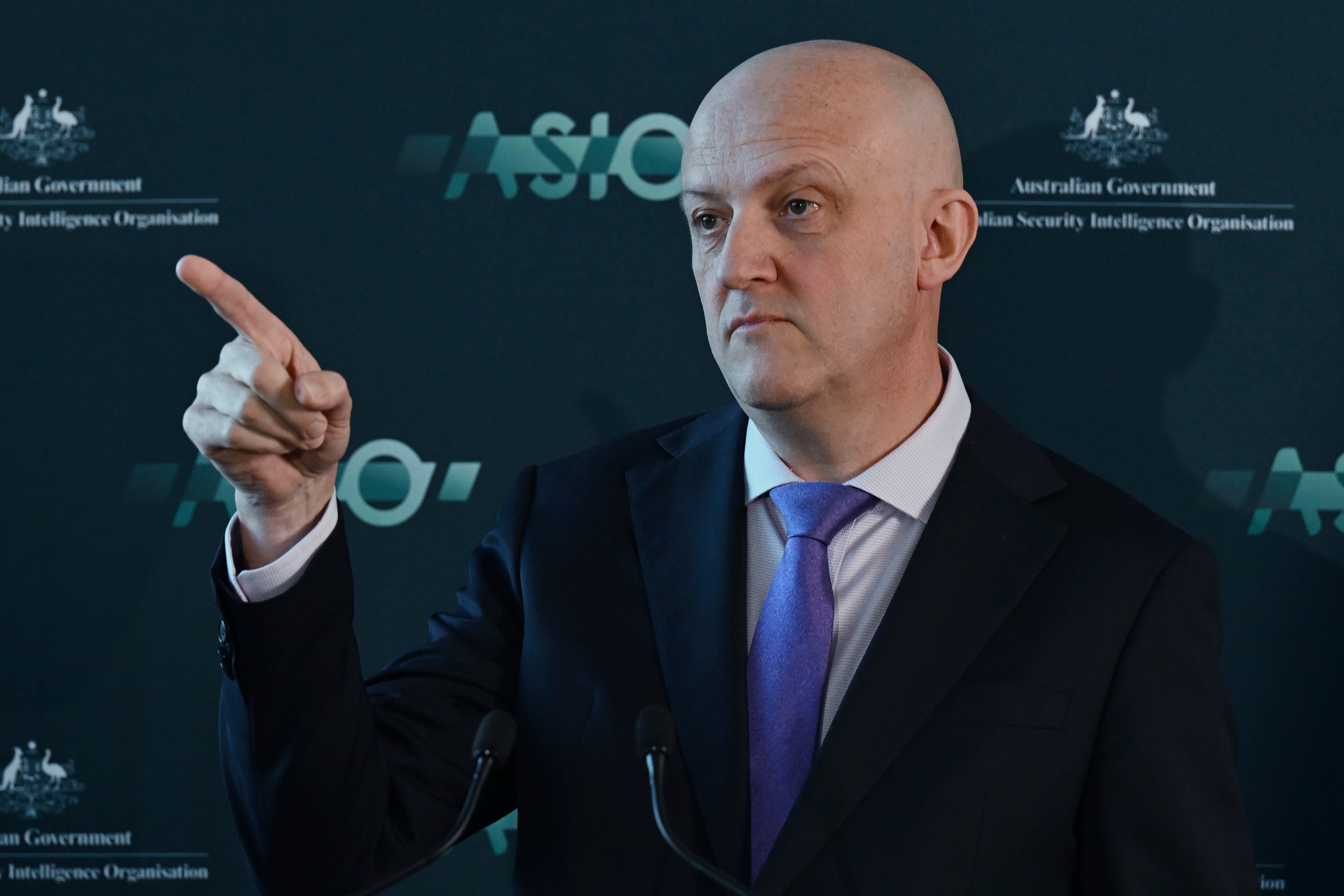 Australian Security Intelligence Organization director-general Mike Burgess points as he talks in Canberra, Australia