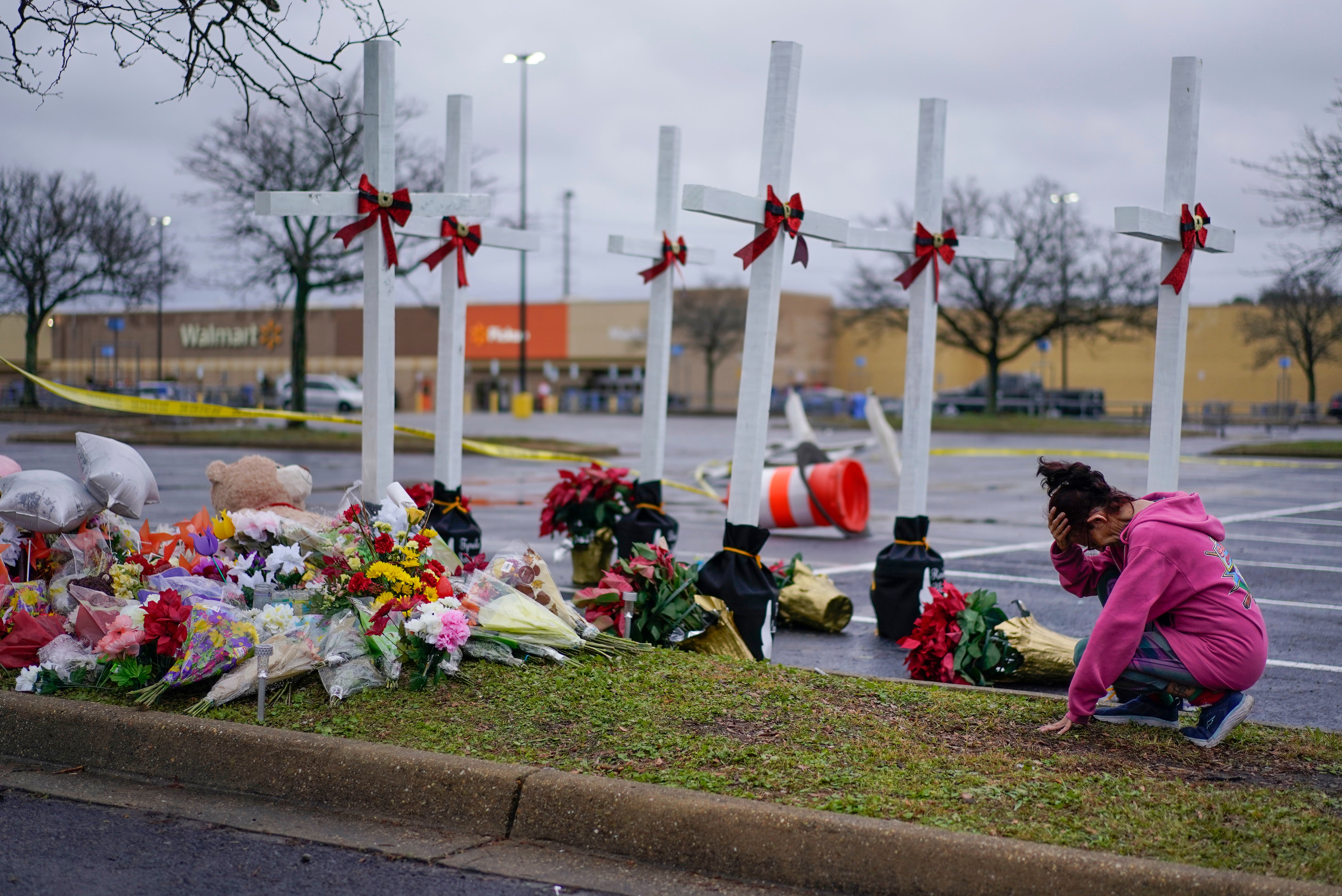 Mourners at a memorial for the victims of a mass shooting at a Virginia Walmart