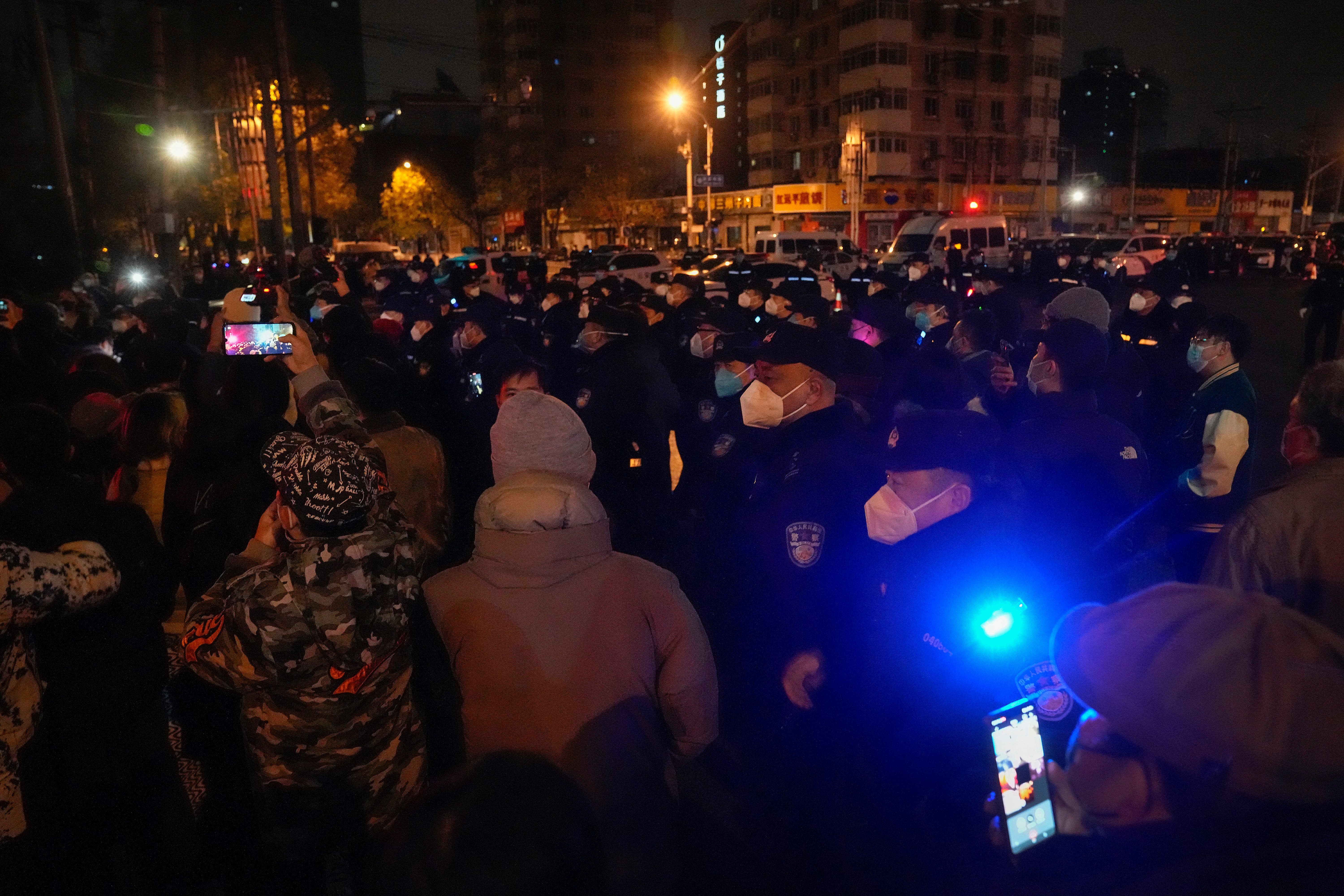 Protesters confront policemen during a protest in Beijing