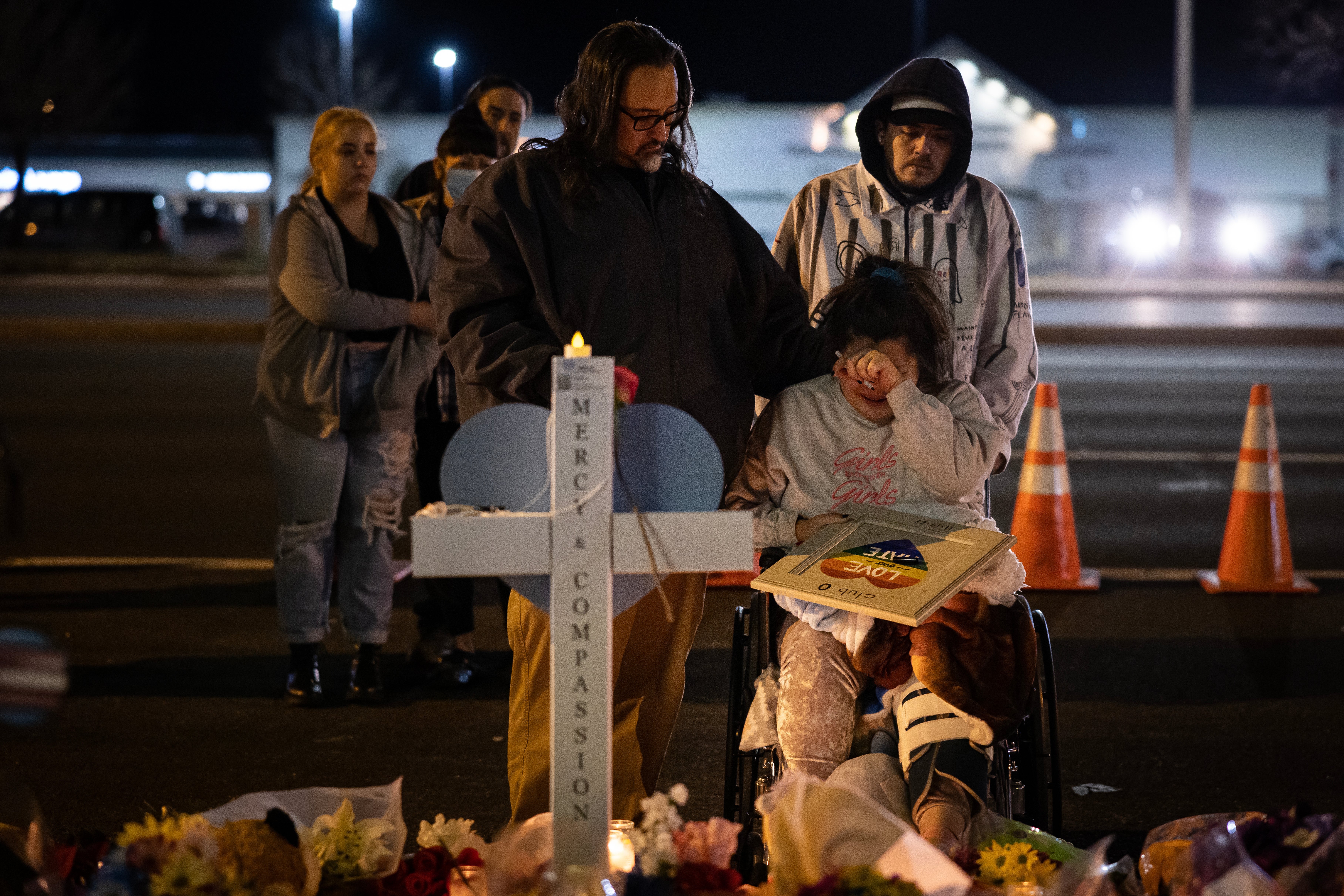 Richard Fierro consoles his daughter Kassandra on 22 November at a memorial for her boyfriend who was fatally shot during a mass shooting at Club Q in Colorado Springs