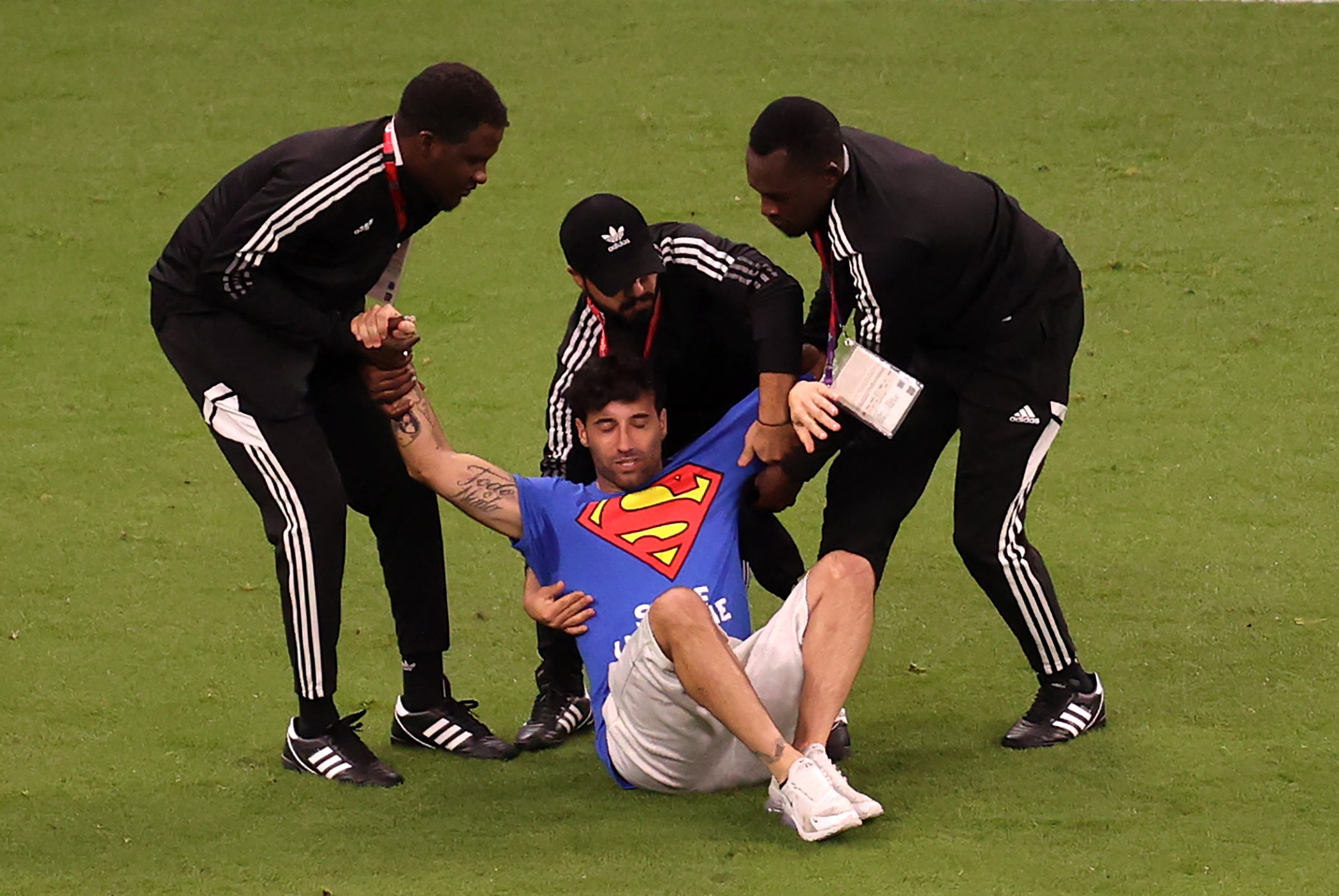 A pitch invader is caught by security during the FIFA World Cup 2022 group H soccer match between Portugal and Uruguay