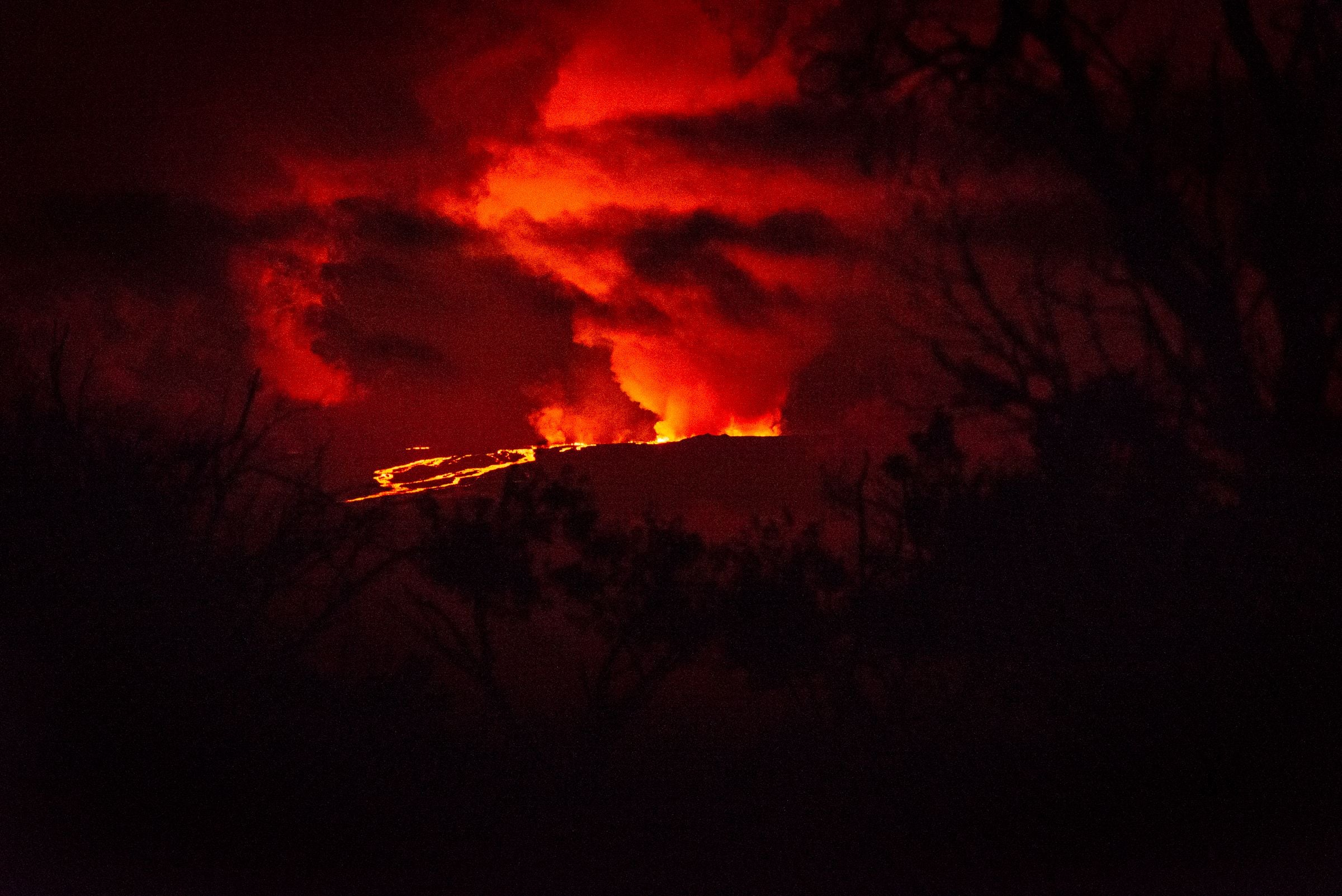 Rivers of molten rock could be seen high up on the volcano, venting huge clouds of steam and smoke at the summit on Big Island