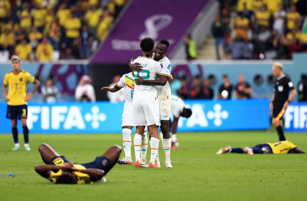 Senegal players embrace at the final whistle