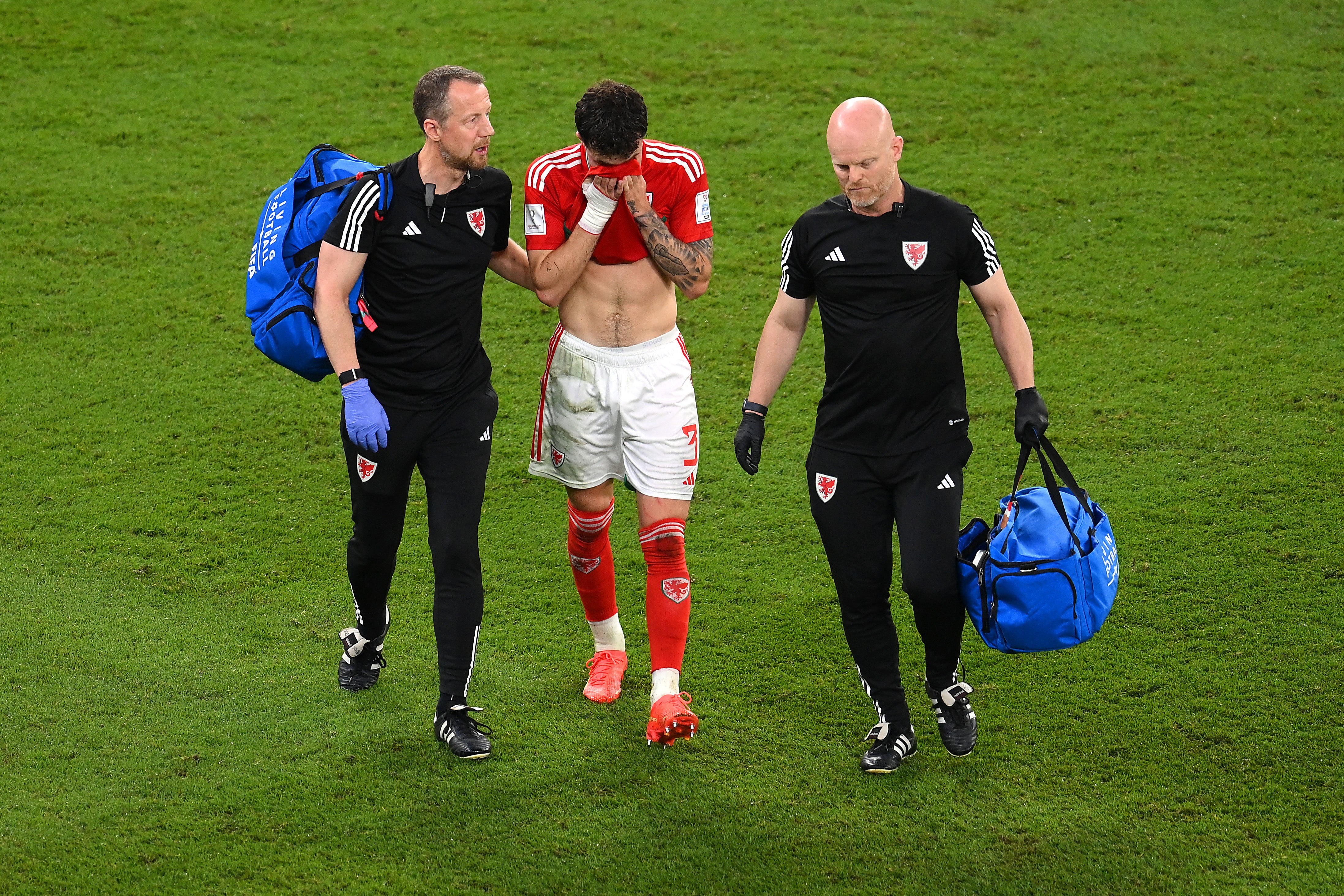 Neco Williams walks off the pitch as he is substituted after a head injury