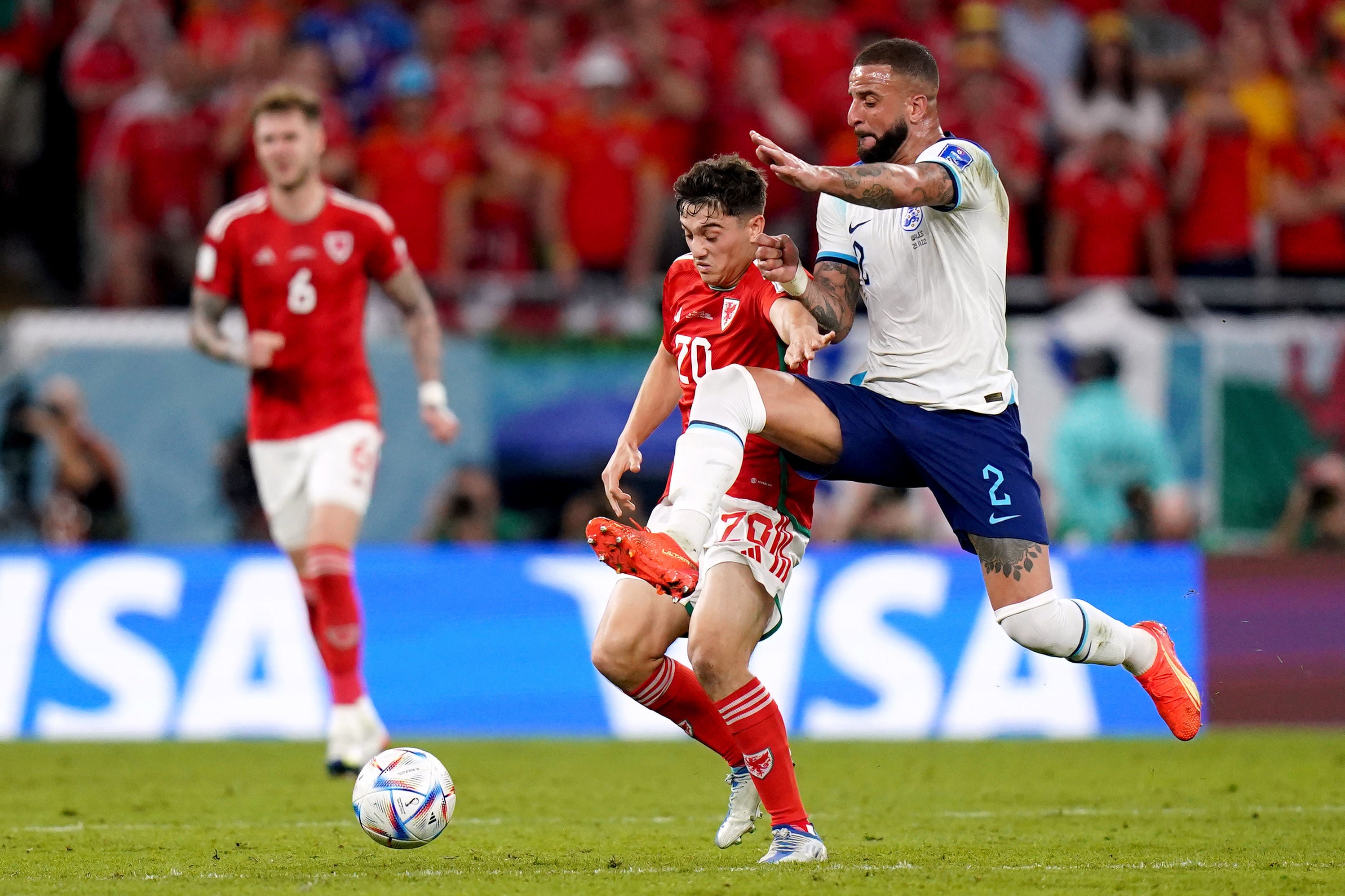 England's Kyle Walker battles for possession of the ball with Wales' Daniel James