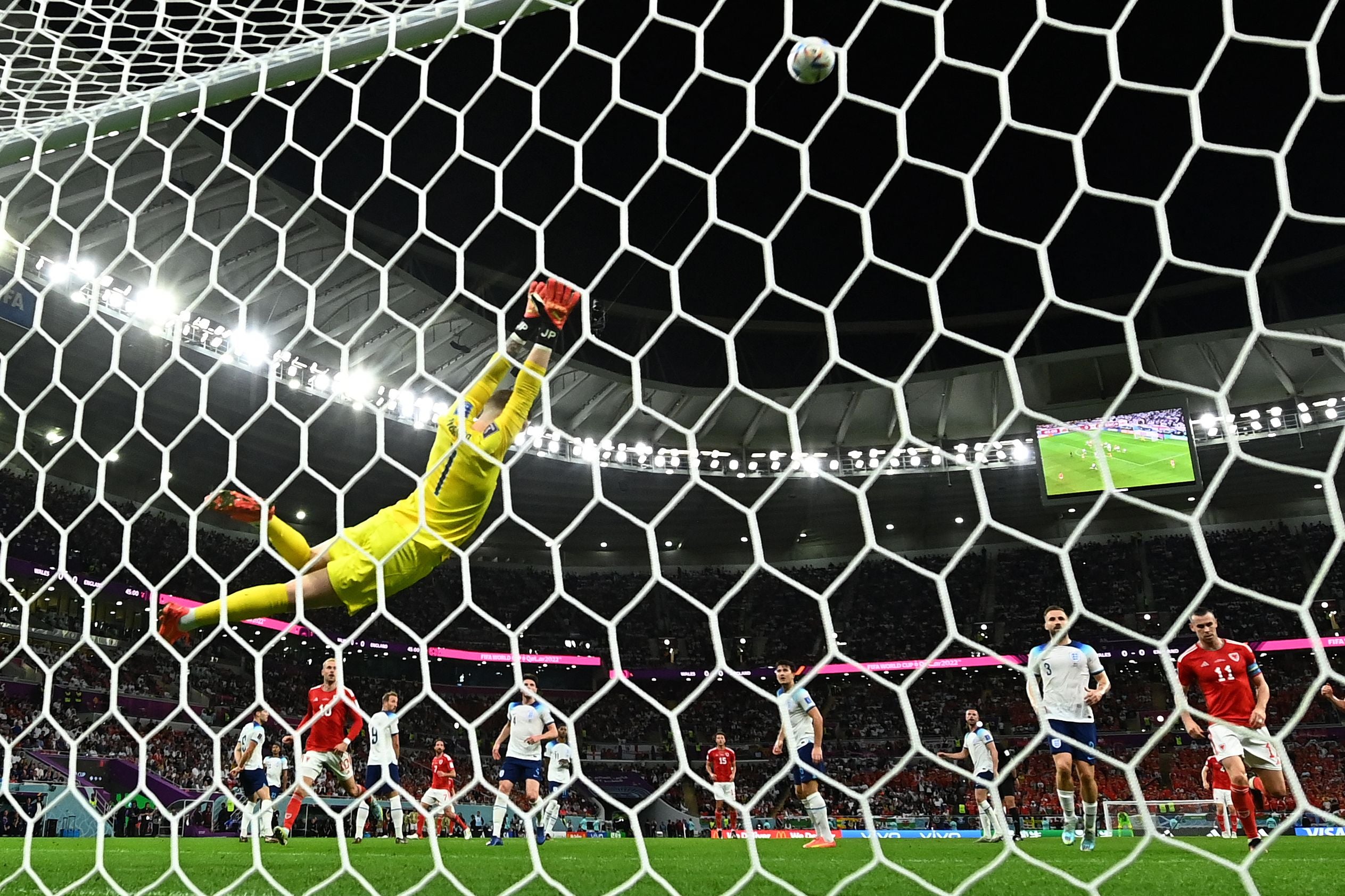 Jordan Pickford dives at a Wales shot