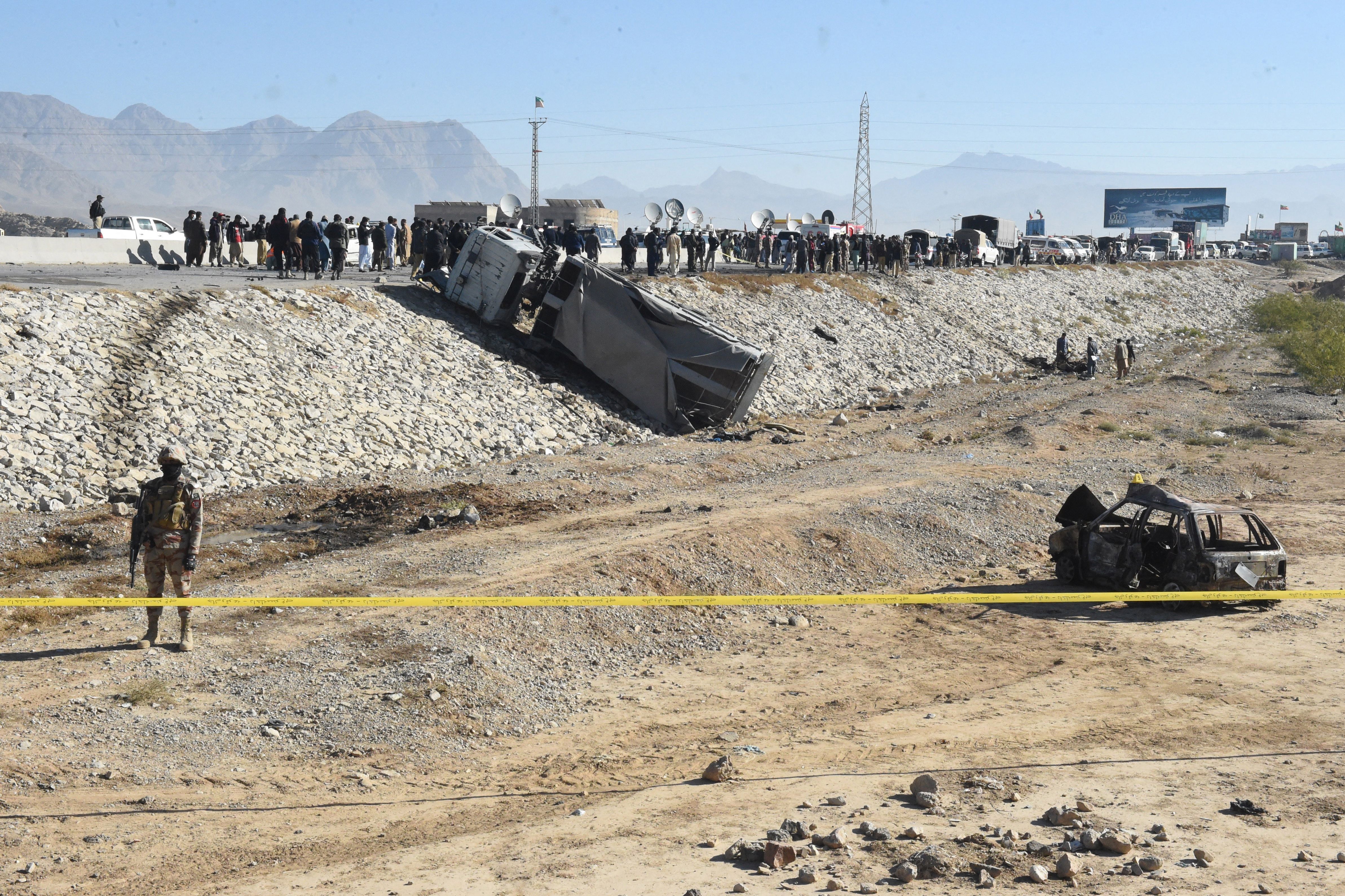 A security official stands guard at the site of a suicide bomb attack targeting a police truck in Quetta on 30 November 2022