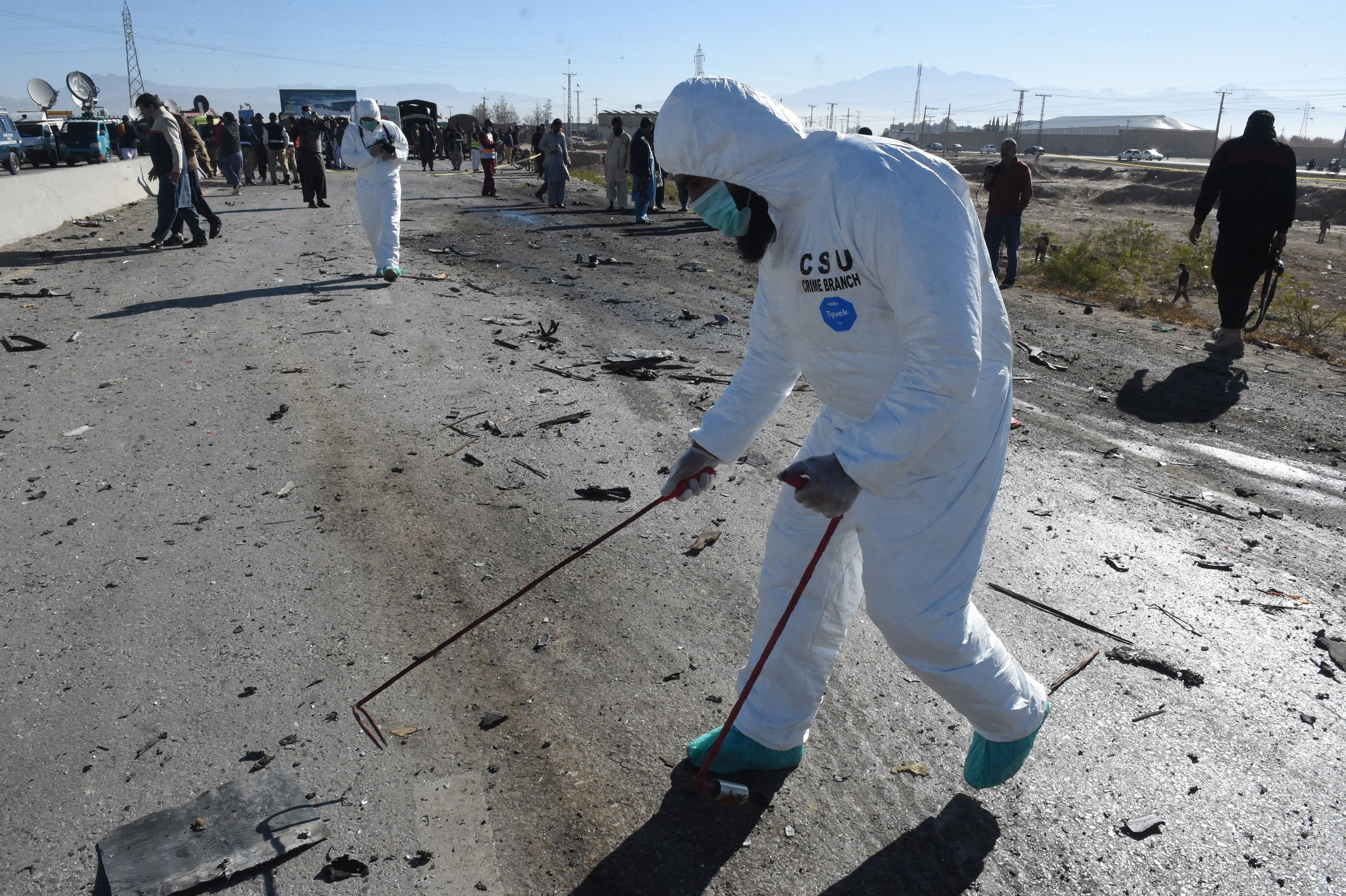 Security officials inspect the site of the suicide bomb attack in Quetta