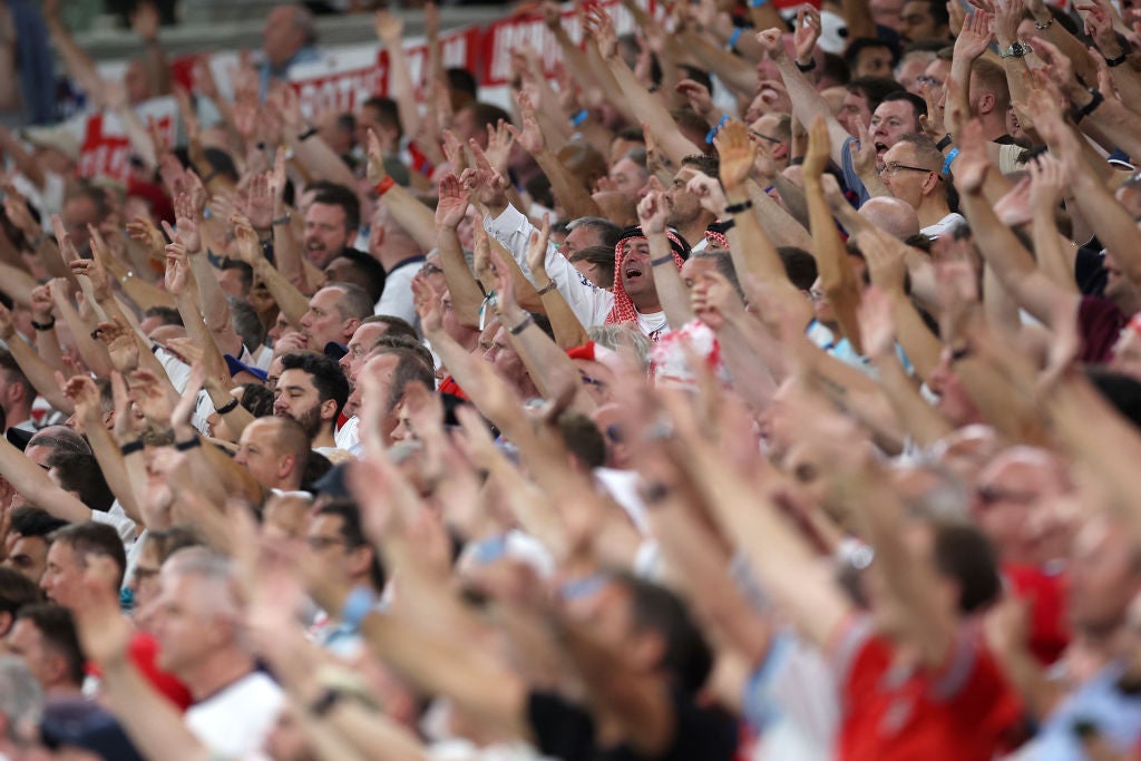 England fans cheer during the match between Wales at Ahmad Bin Ali Stadium