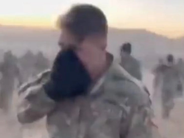 A member of the US Army’s 4th Infantry Division covers his mouth and nose to protect himself from CS gas after the irritant accidentally spread throughout a morale boosting event in Fort Carson, Colorado