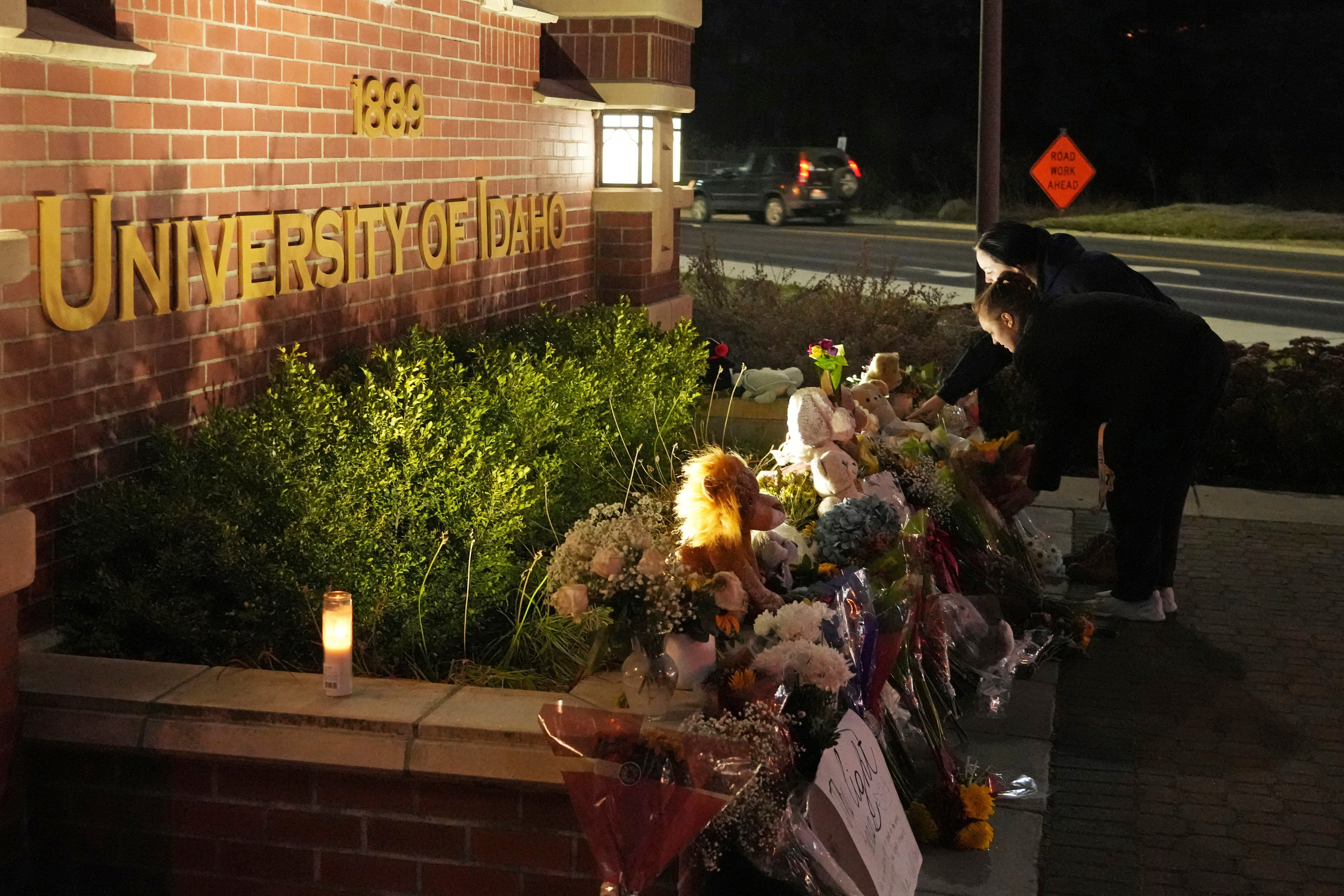 A growing memorial in front of a campus entrance sign for the University of Idaho