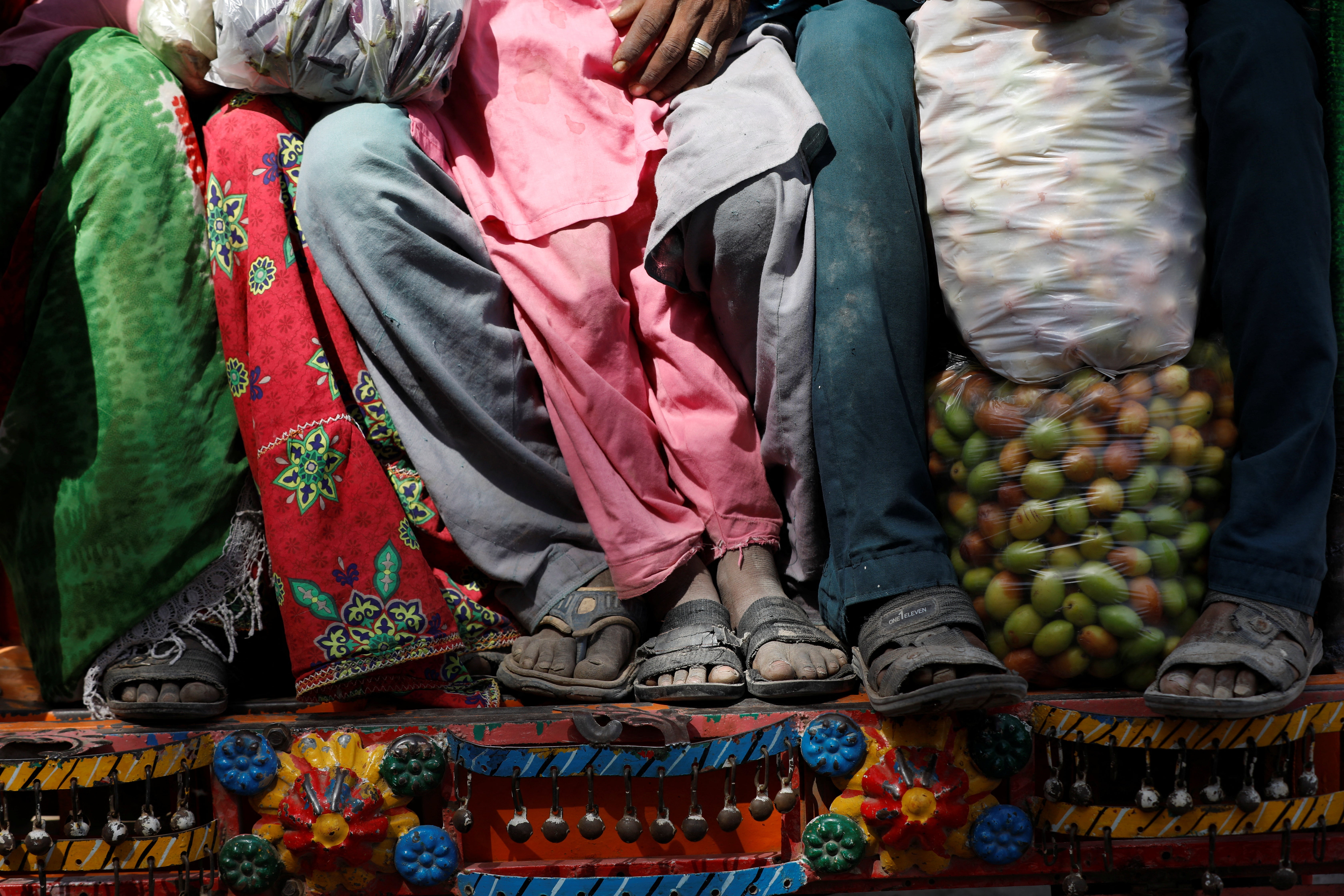 People ride a rickshaw