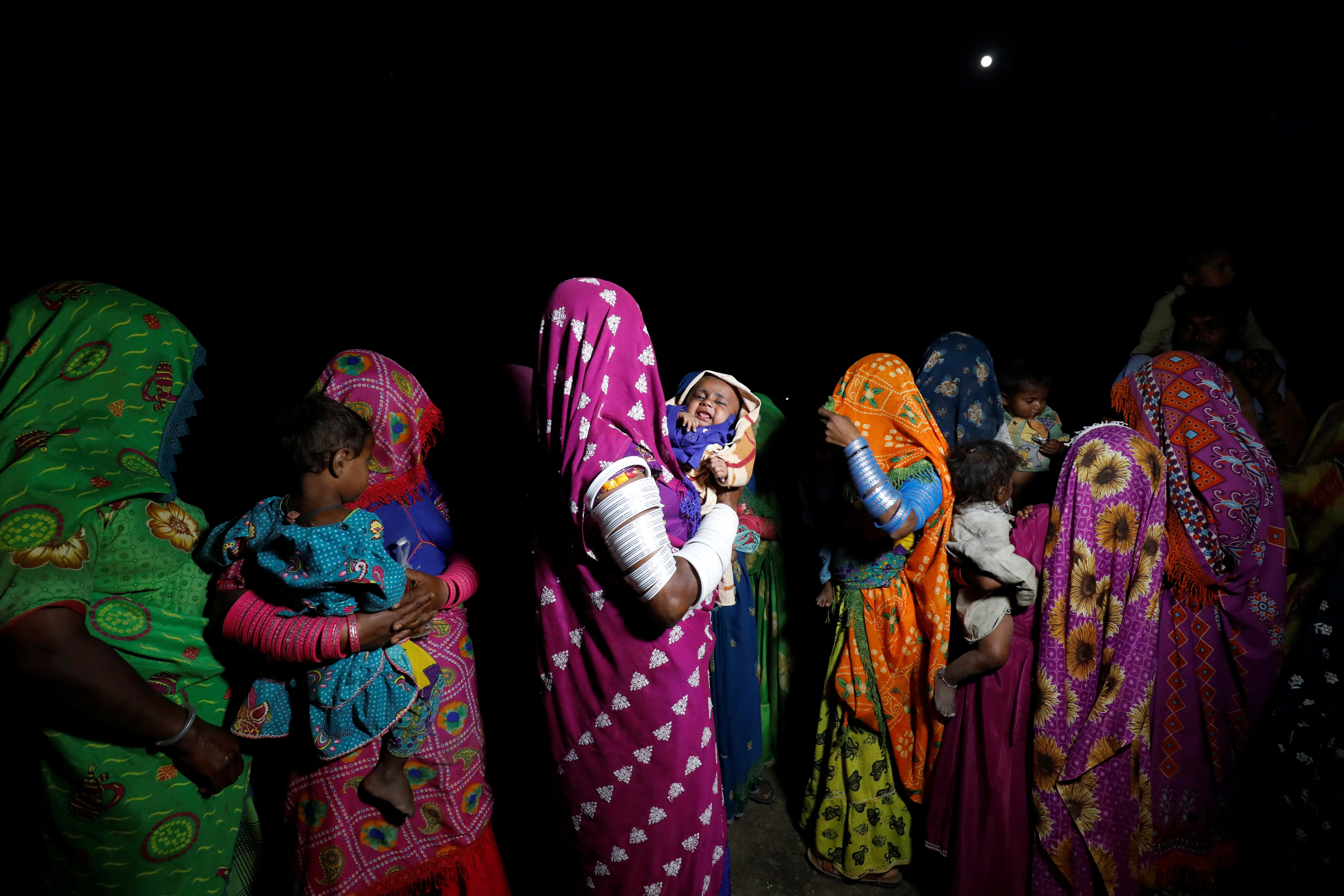 Farmers wearing traditional clothes gather to celebrate Holi, the Festival of Colours