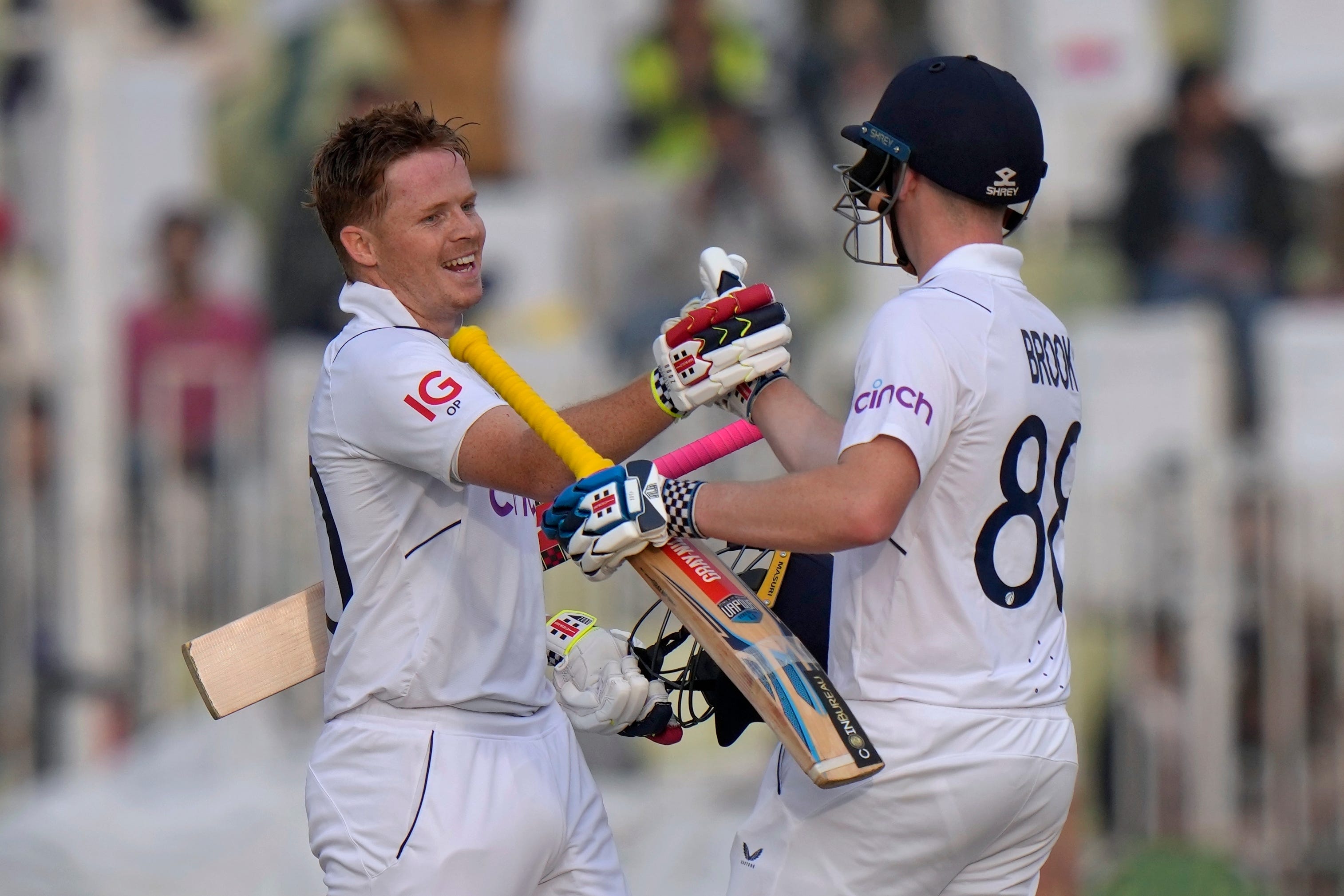 England’s Ollie Pope, left, celebrates with Harry Brook (AP)