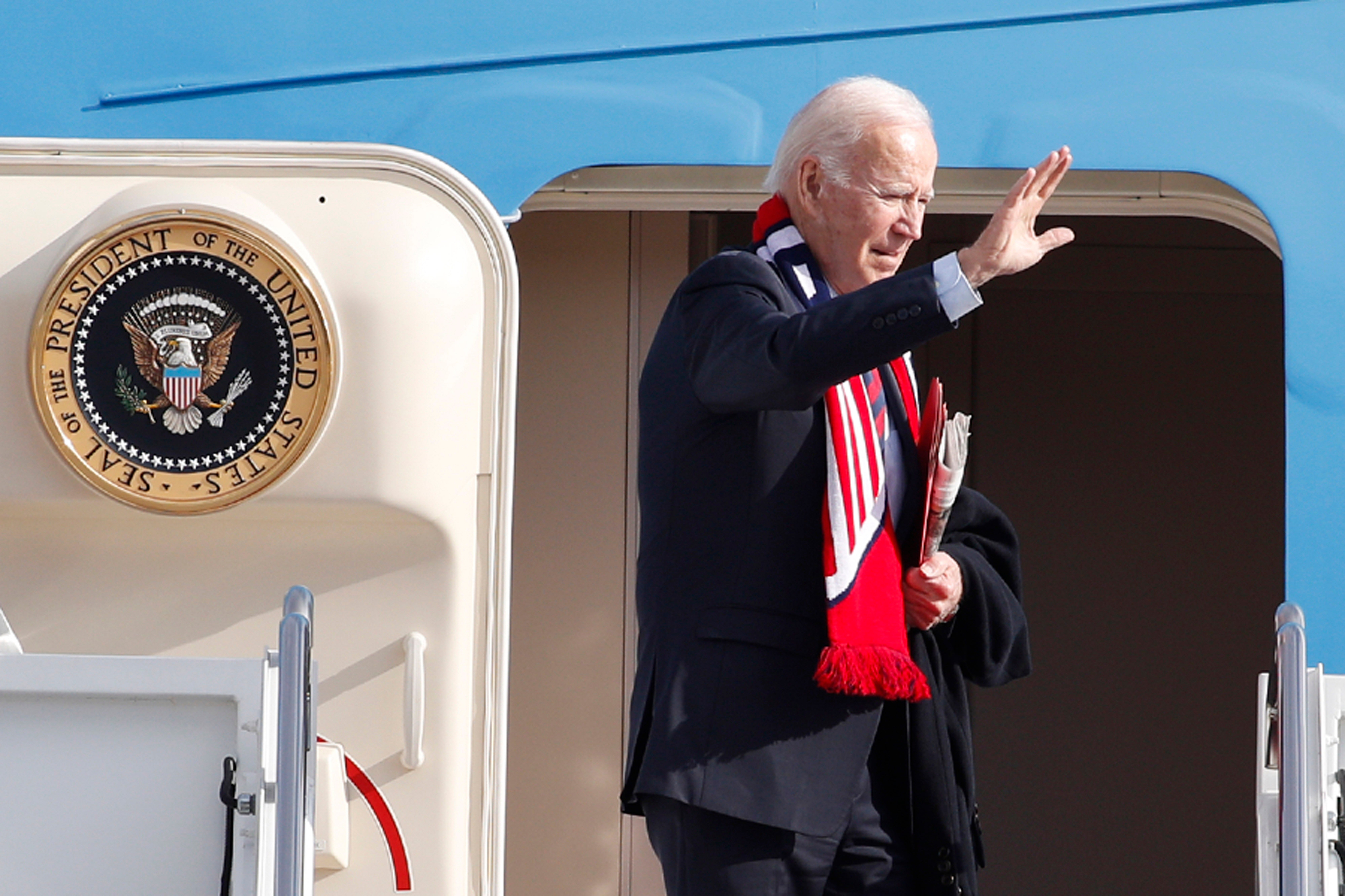 President Joe Biden waves from the stairs of Air Force One at Andrews Air Force Base, Md., Friday, Dec. 2, 2022