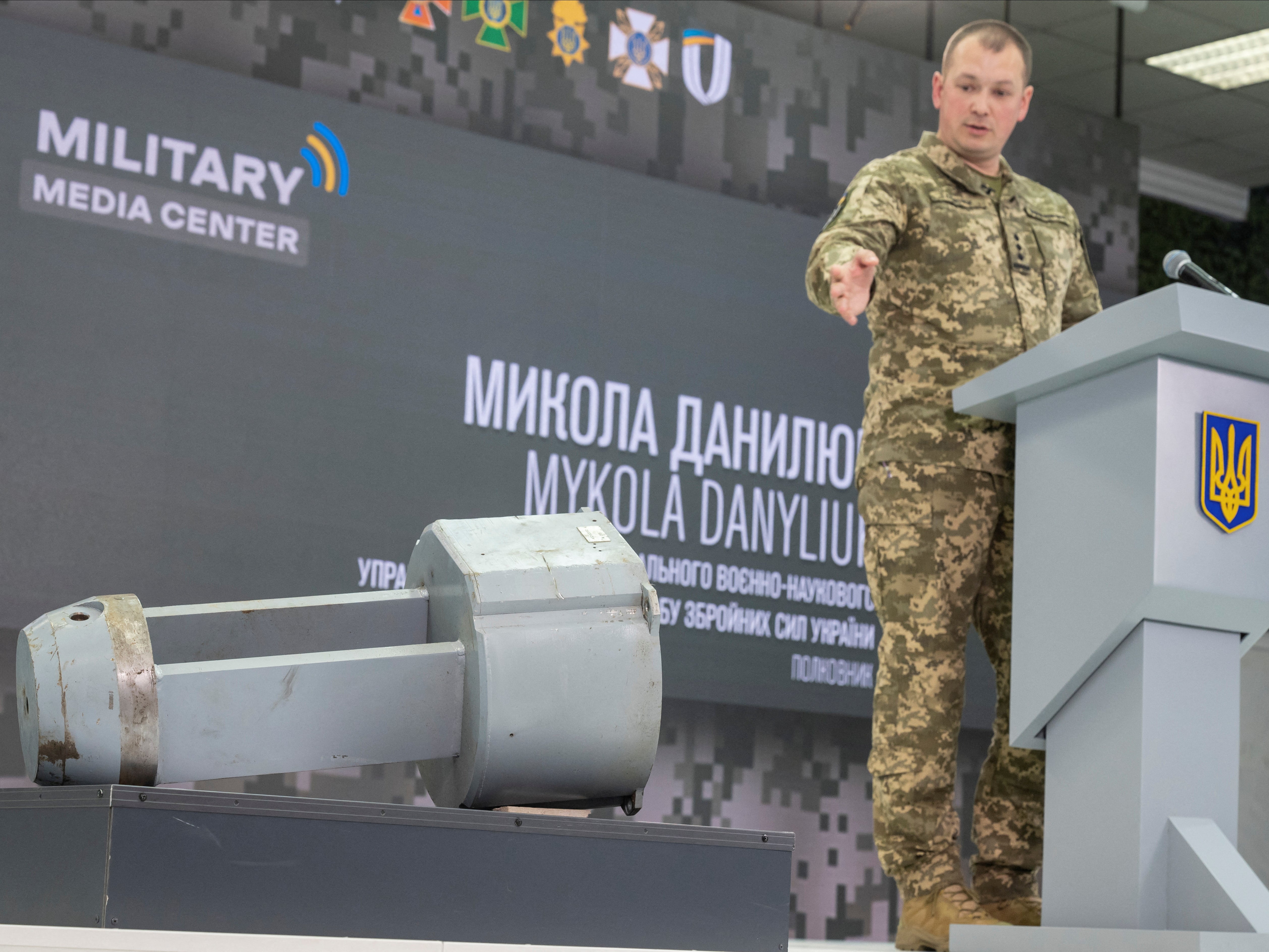 Colonel Mykola Danyliuk points at a dud warhead imitating a nuclear part of a Kh-55SM strategic cruise missile,