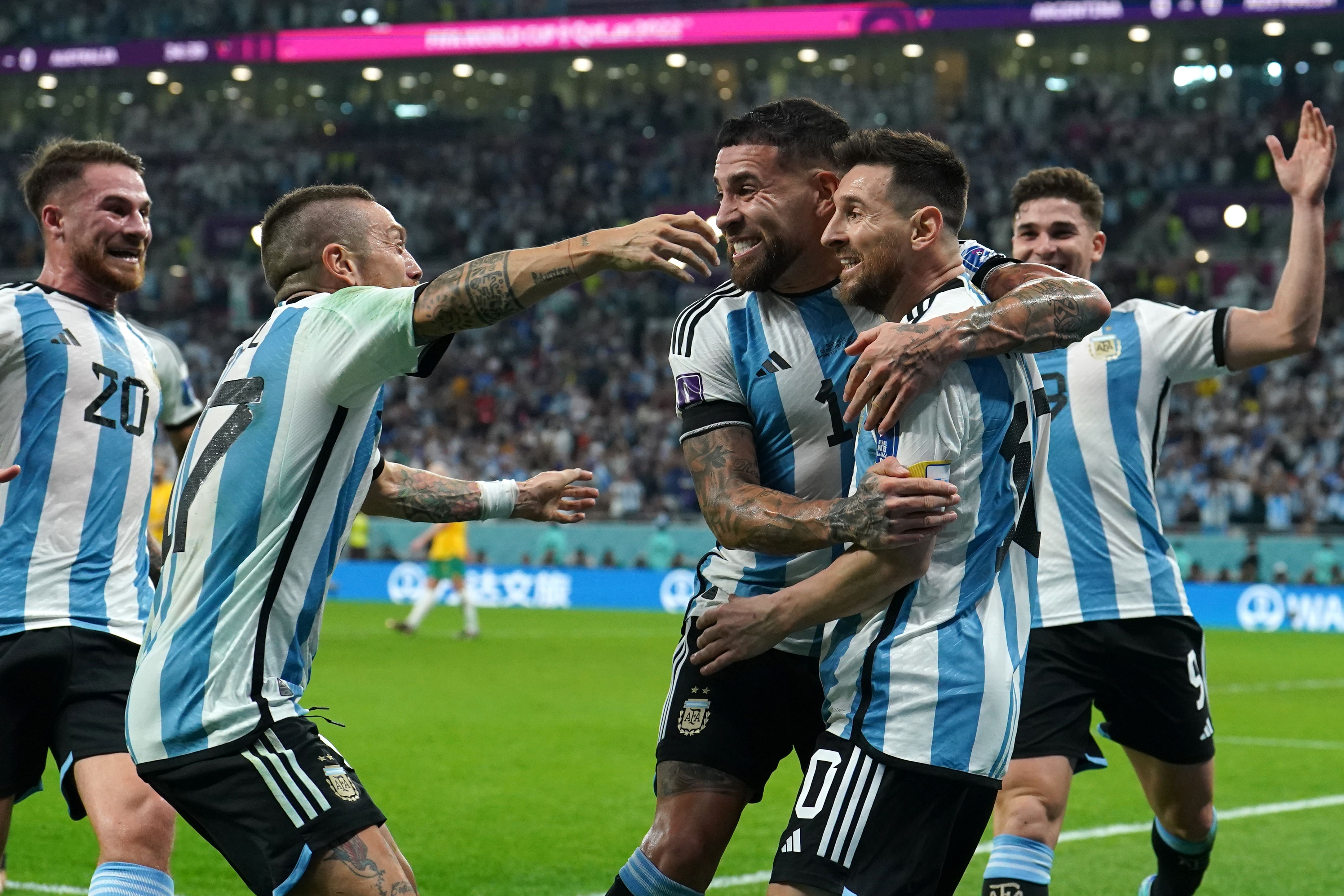 Lionel Messi is mobbed by his team-mates after scoring Argentina’s opening goal