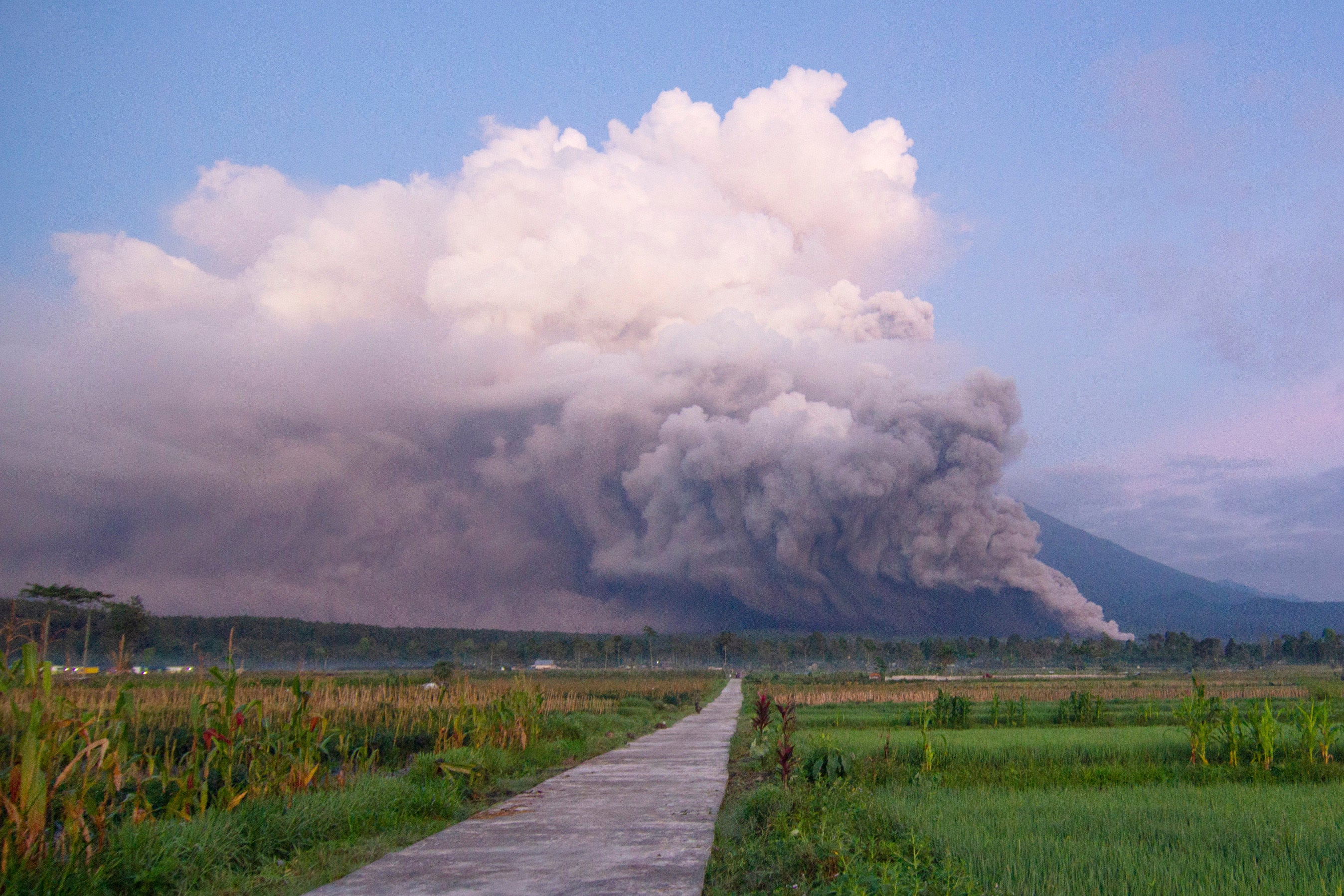 Mount Semeru releases volcanic materials during an eruption on Sunday