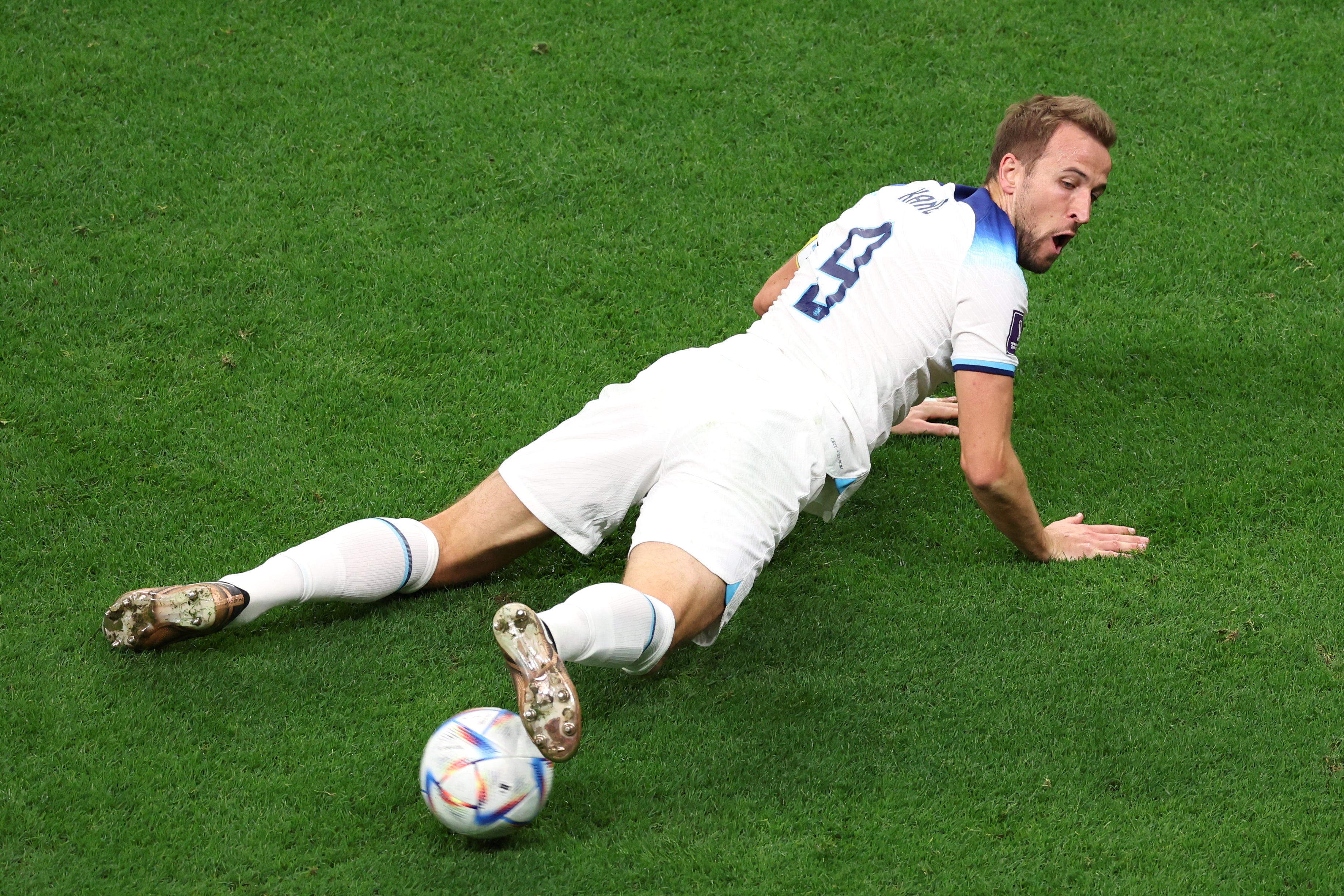 Kane steadies the ball from a prone position