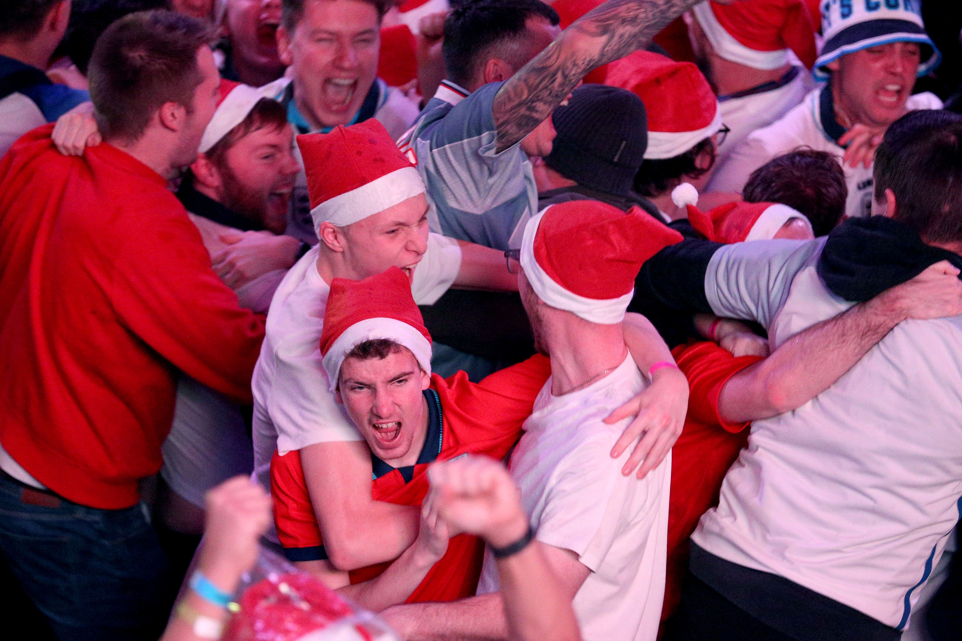 England fans celebrate their second goal of the game at BOXPARK Wembley in London, watch a screening of the Fifa World Cup 2022 Round of Sixteen match between England and Senegal