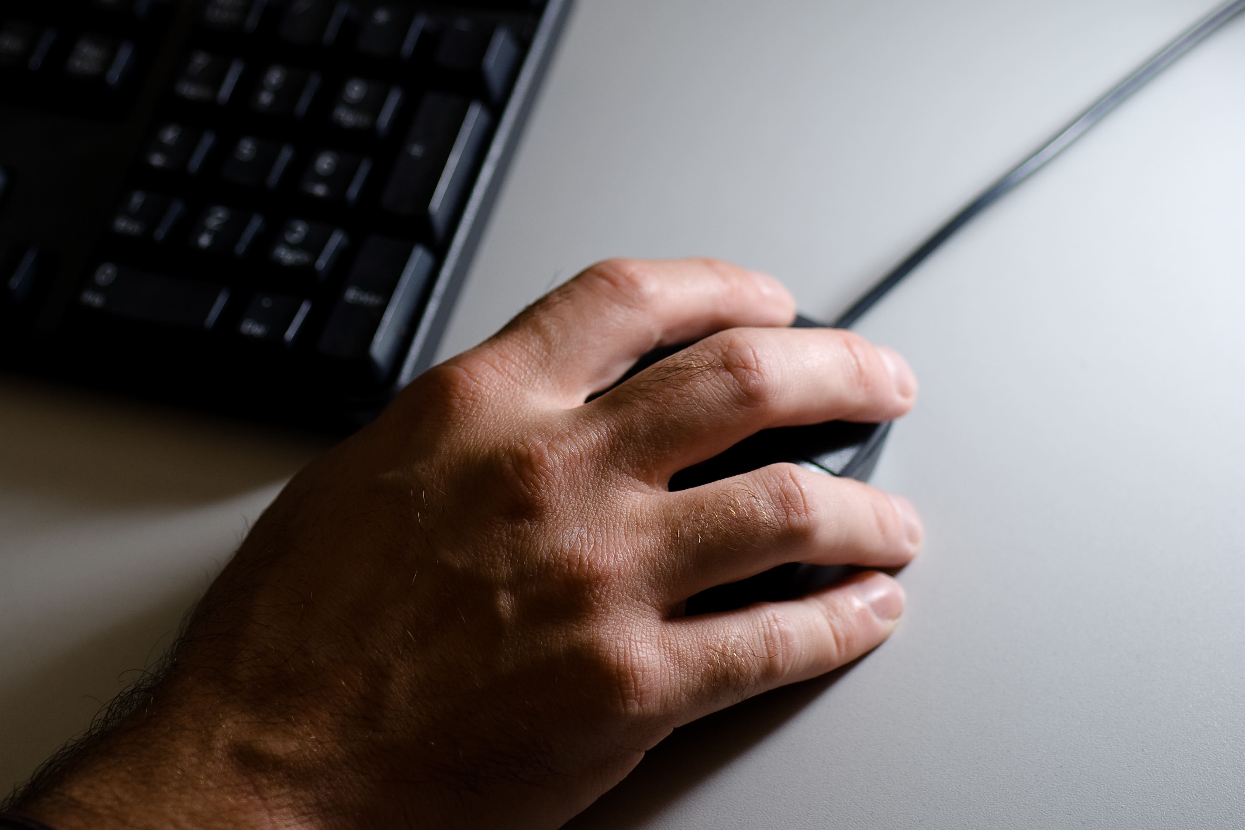 Detail of an office worker working at a computer workstation (Adam Peck/PA)