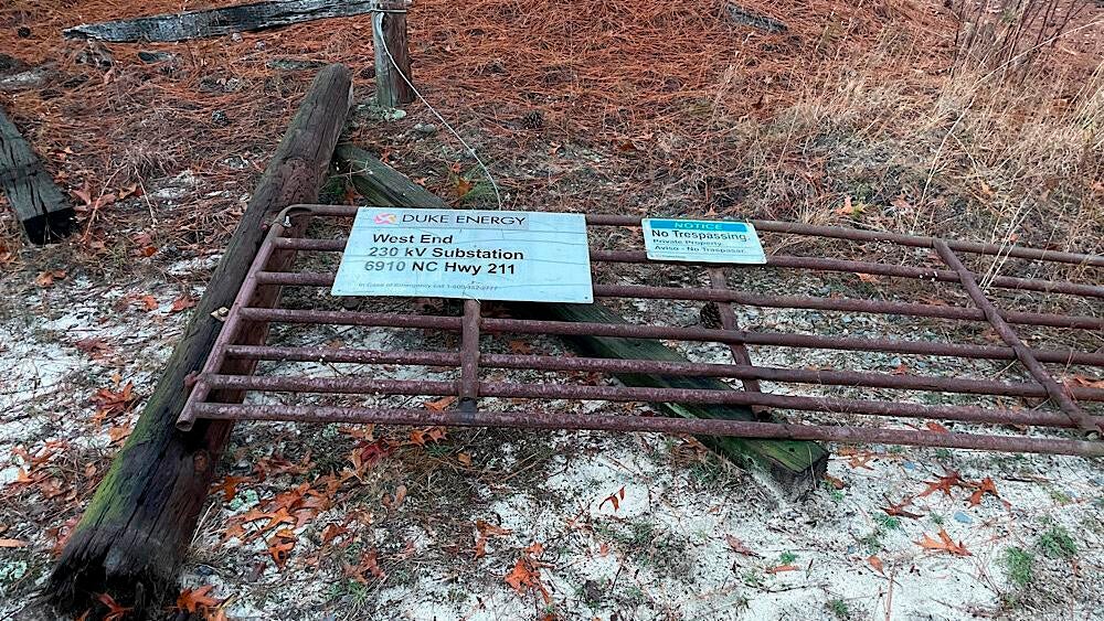 A vandalised door to the Duke Energy West End substation lying on the ground