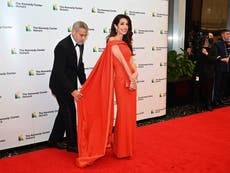 George Clooney fixes wife Amal Clooney’s dress on red carpet at awards ceremony 