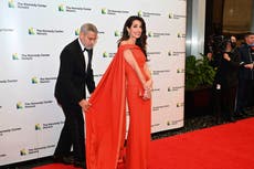 George Clooney fixes wife Amal Clooney’s dress on red carpet at awards ceremony