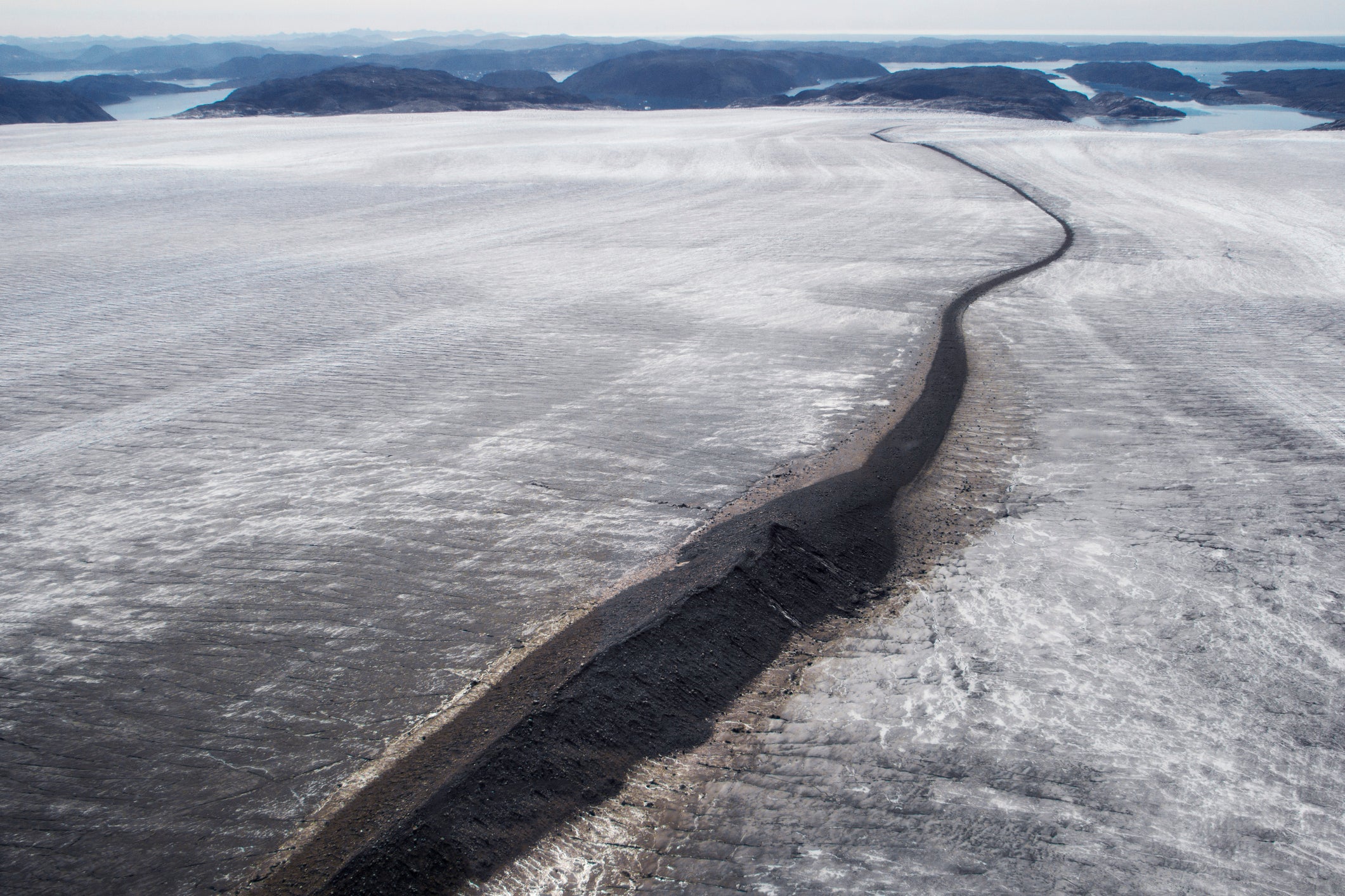 A melting glacier showing the rock hidden for millennia beneath the ice in south west Greenland