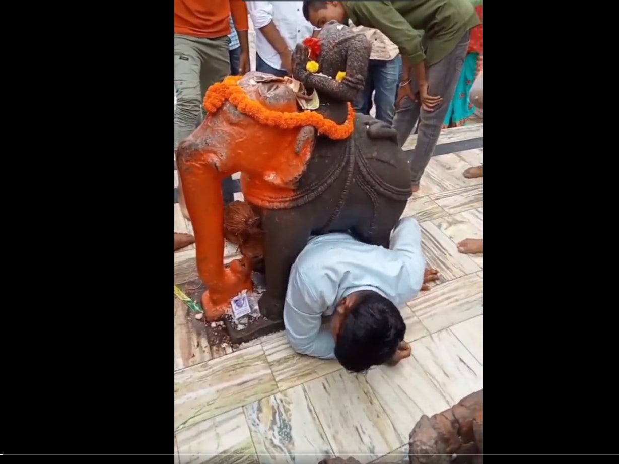 A video of a man in India who got stuck under an elephant statue in a temple has gone viral