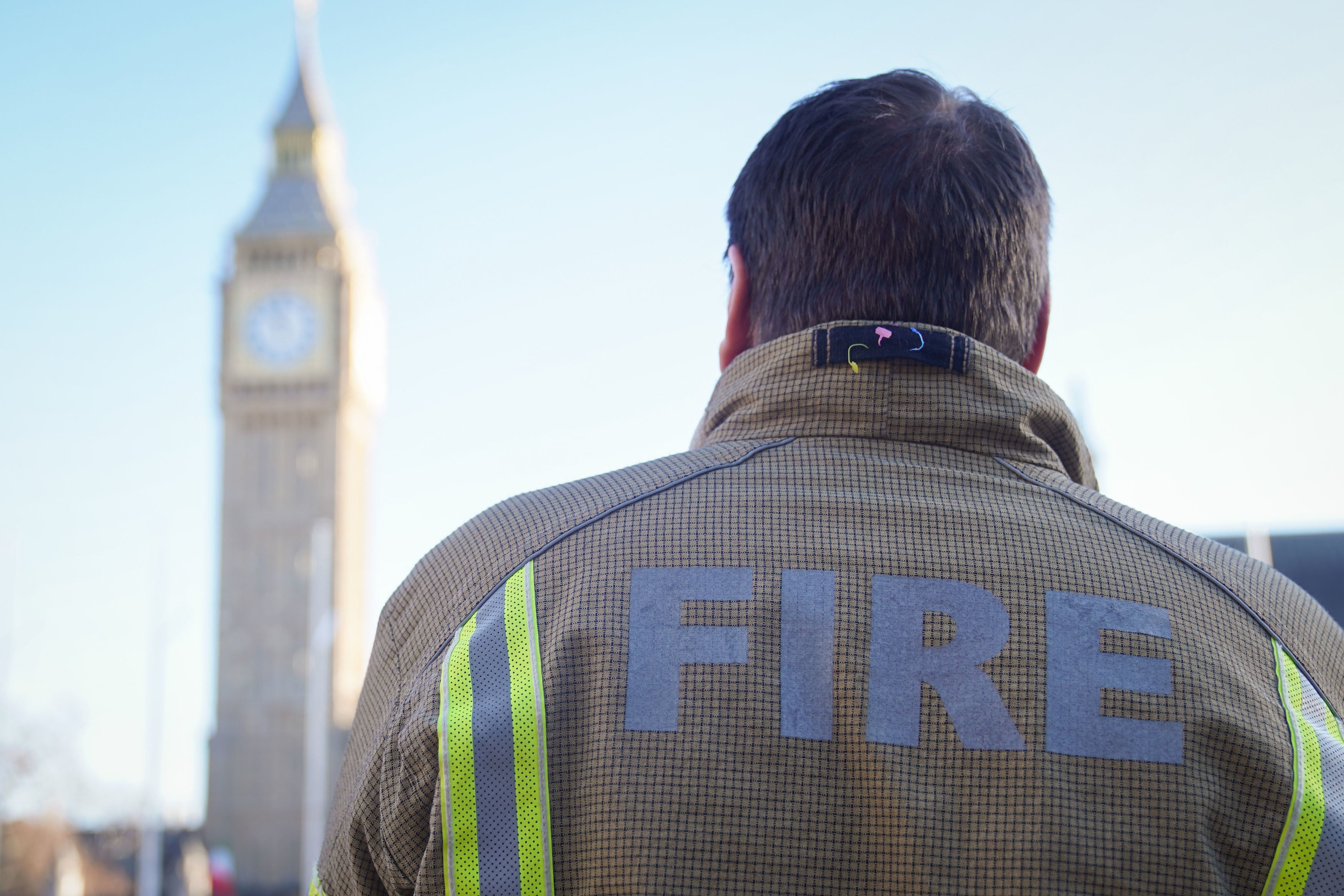 A firefighter in Parliament Square, central London, ahead of a rally to mark the start of a ballot for strikes in a dispute over pay