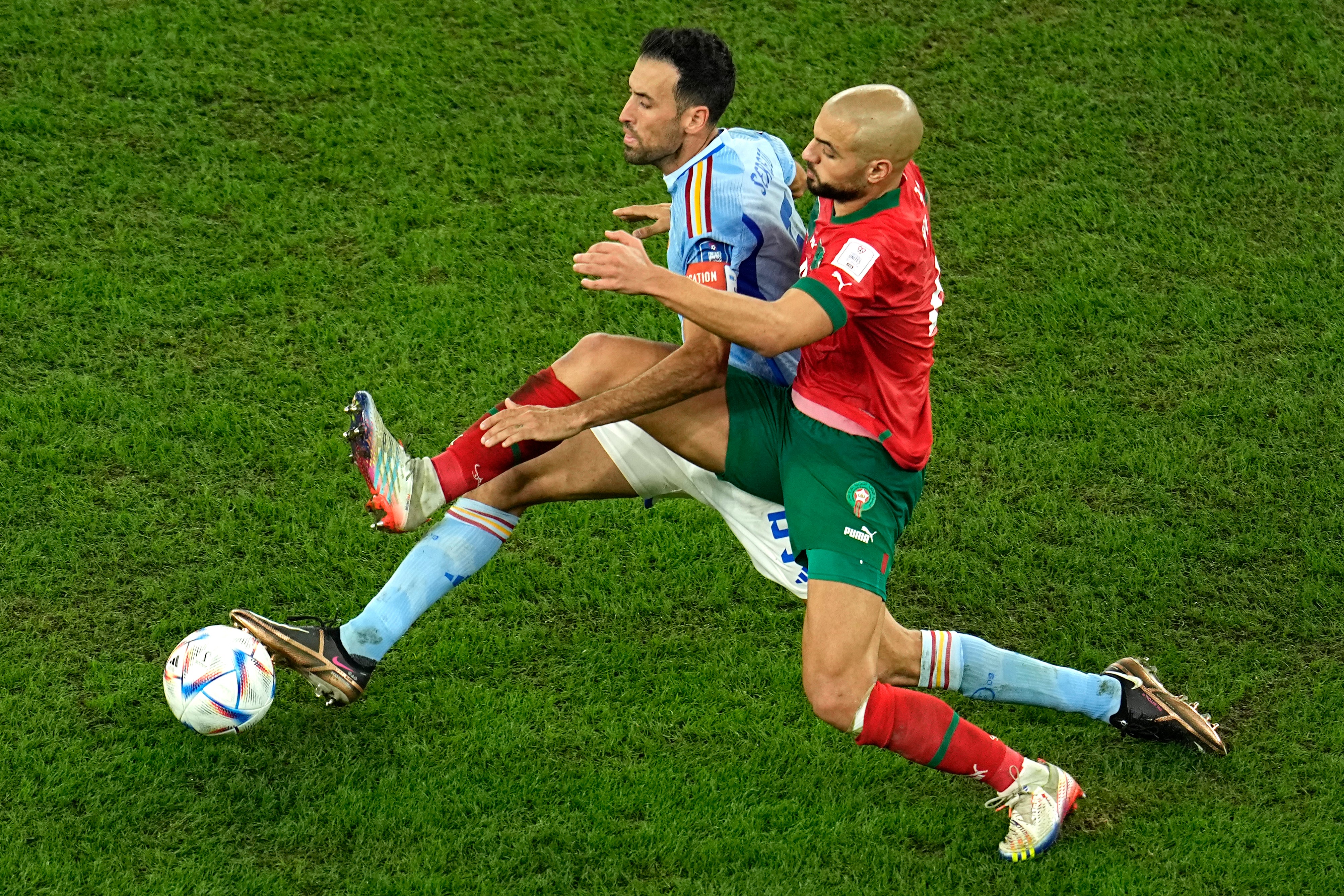 Sofyan Amrabat tackles Spain captain Sergio Busquets