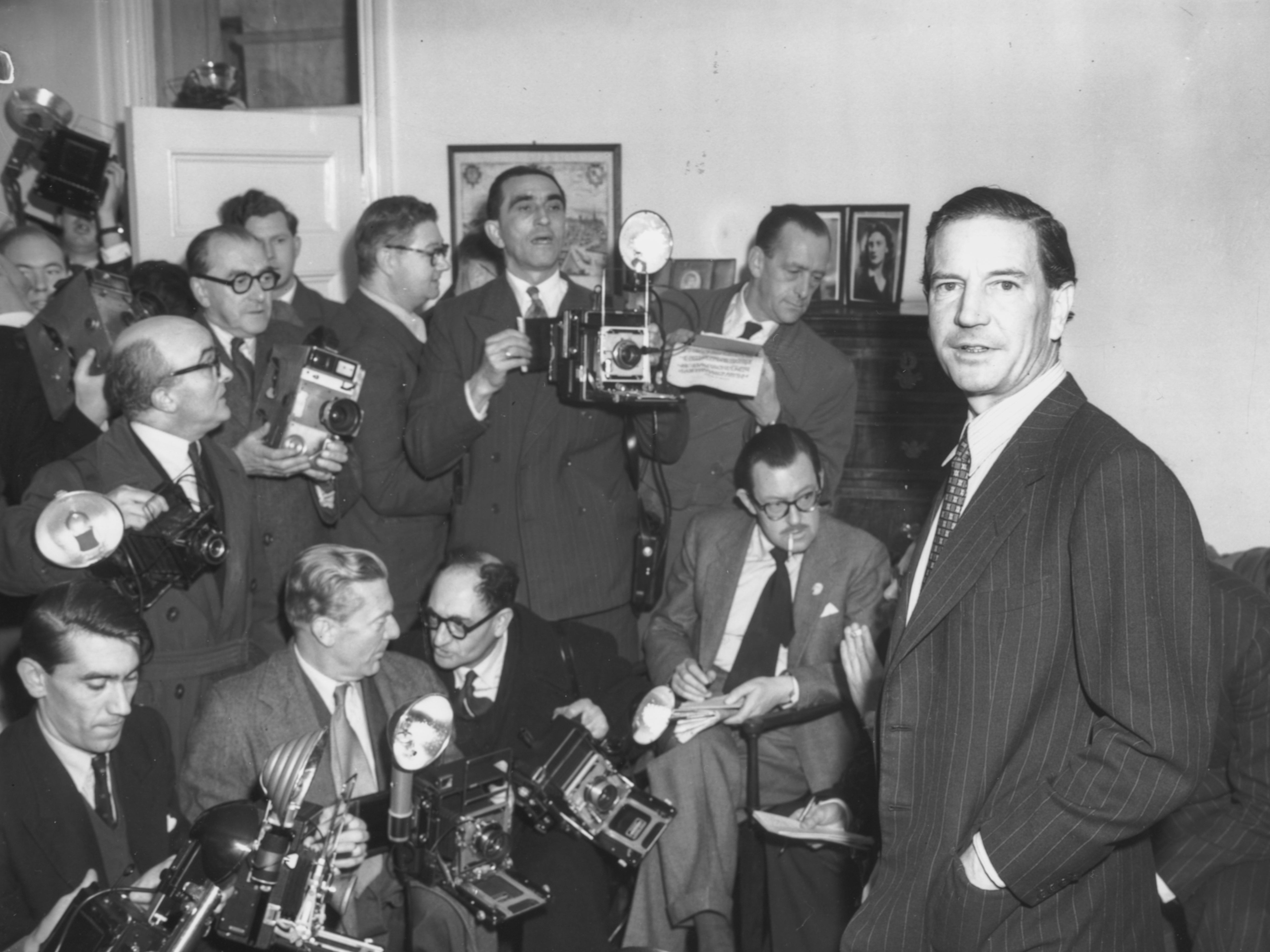 Mr Philby (right) at a London press conference held in response to his involvement with Burgess and McLean, 1955