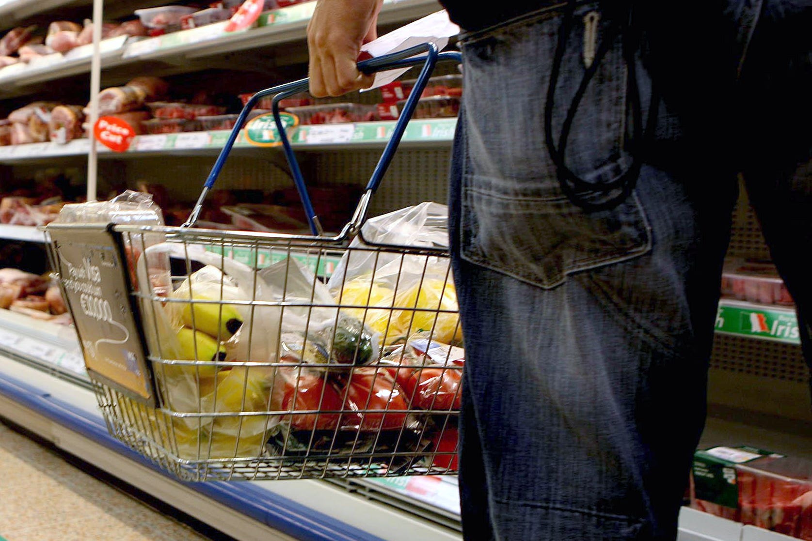 Undated file photo of a person holding a shopping basket in a supermarket.