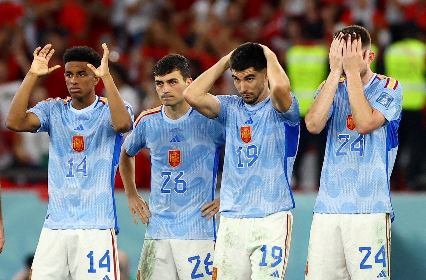 Spain players look dejected after Sergio Busquets has his penalty saved