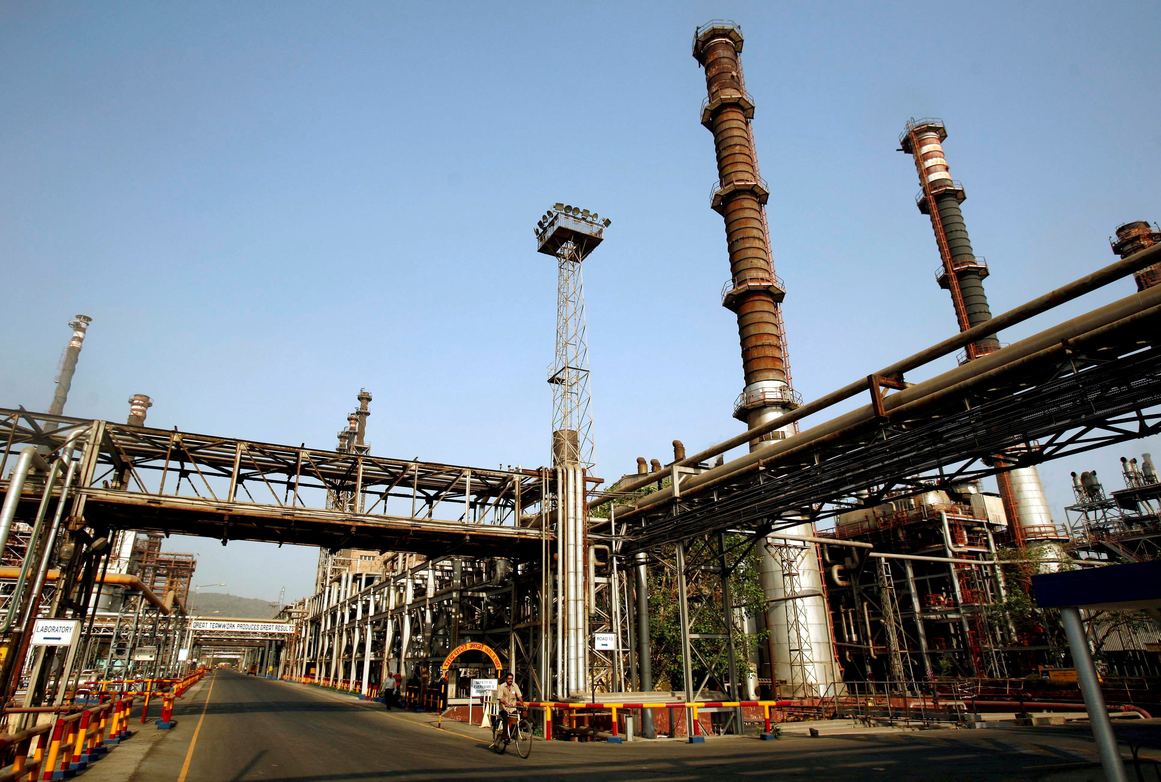 A worker rides a bicycle at the Bharat Petroleum Corporation refinery in Mumbai in 2008