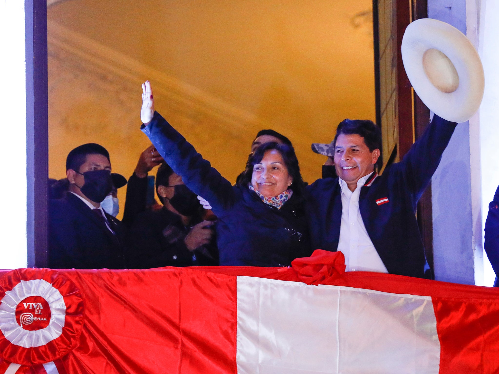 Castillo and Boluarte wave to supporters after taking office in July 2021