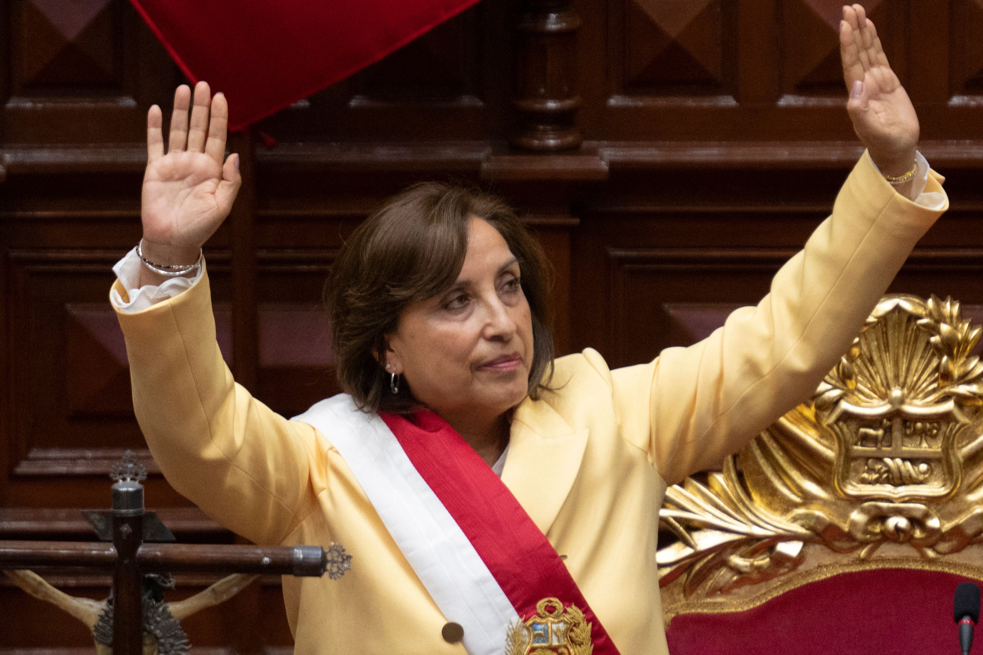 Dina Boluarte greets members of Congress after being sworn in as president